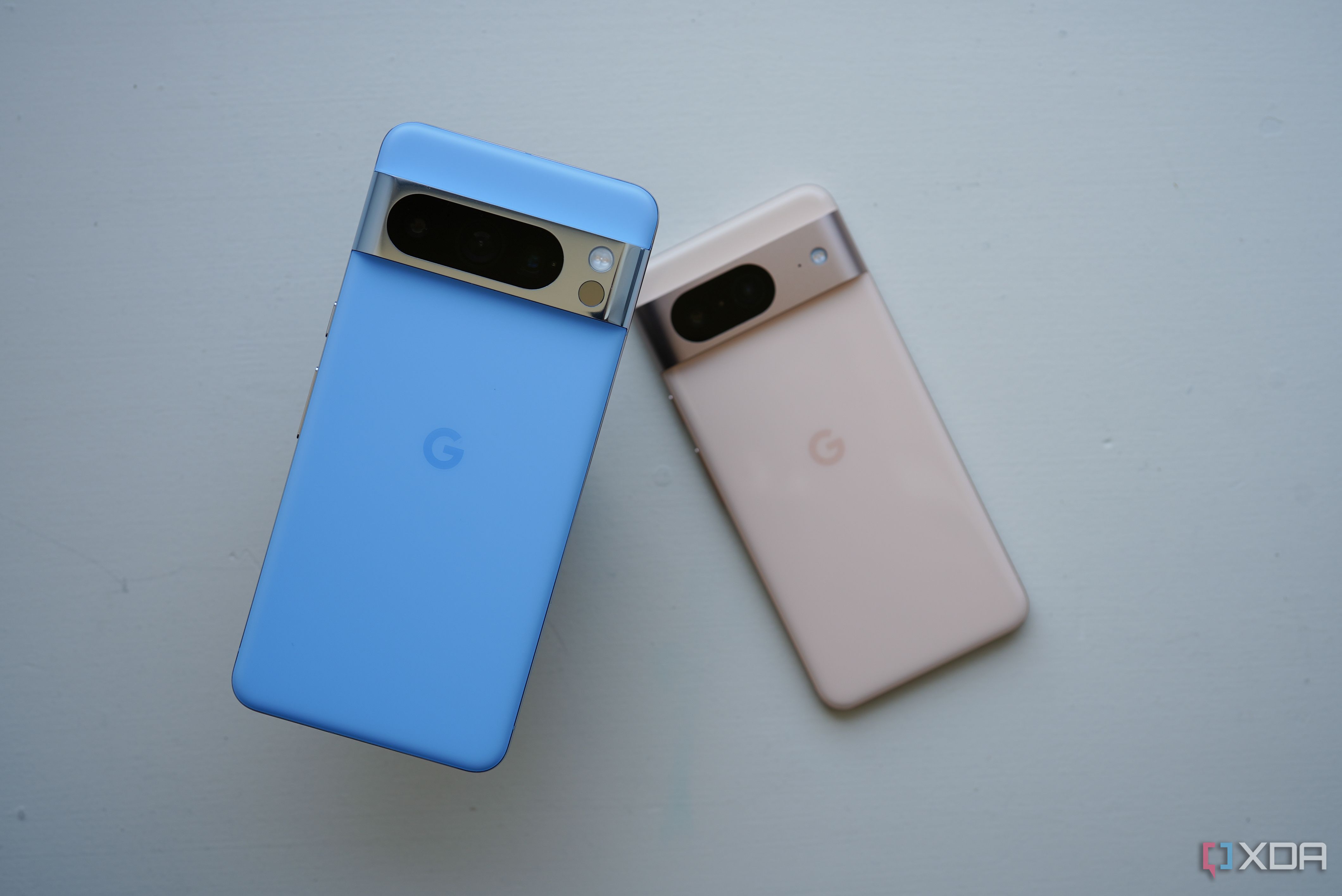 The Google Pixel 8 Pro (left) and Pixel 8 laying flat on a table. 