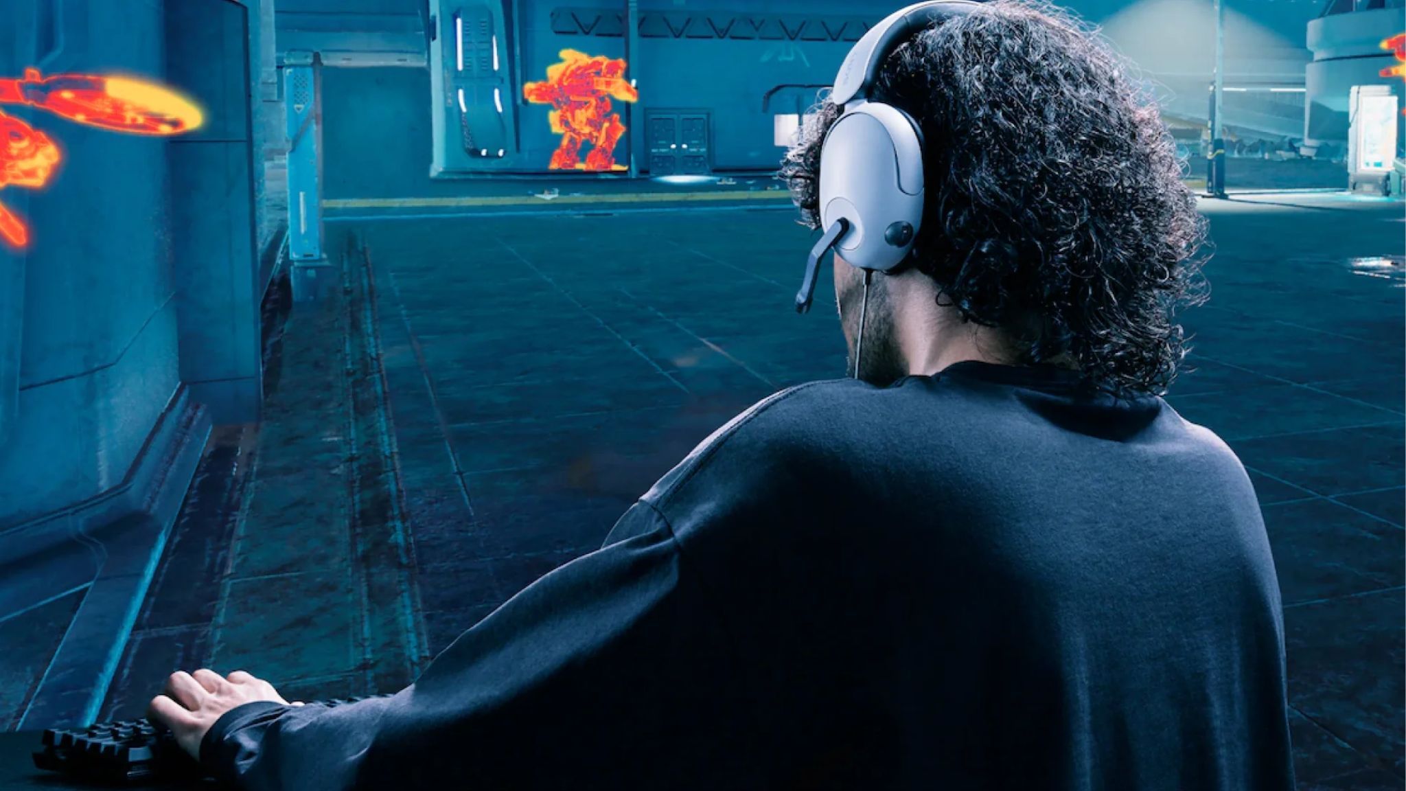 An image showing a person wearing Sony's INZONE H3 wired gaming headset.