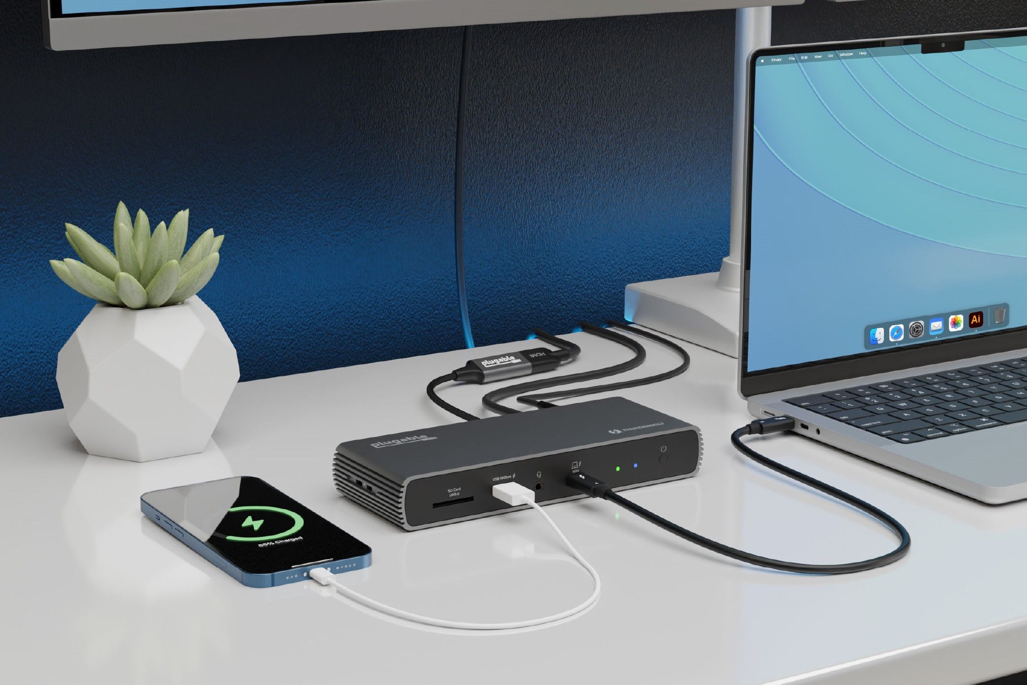 A Plugable THunderbolt 4 docking station (TBT4-UDX1) on a desk with multiple devices connected