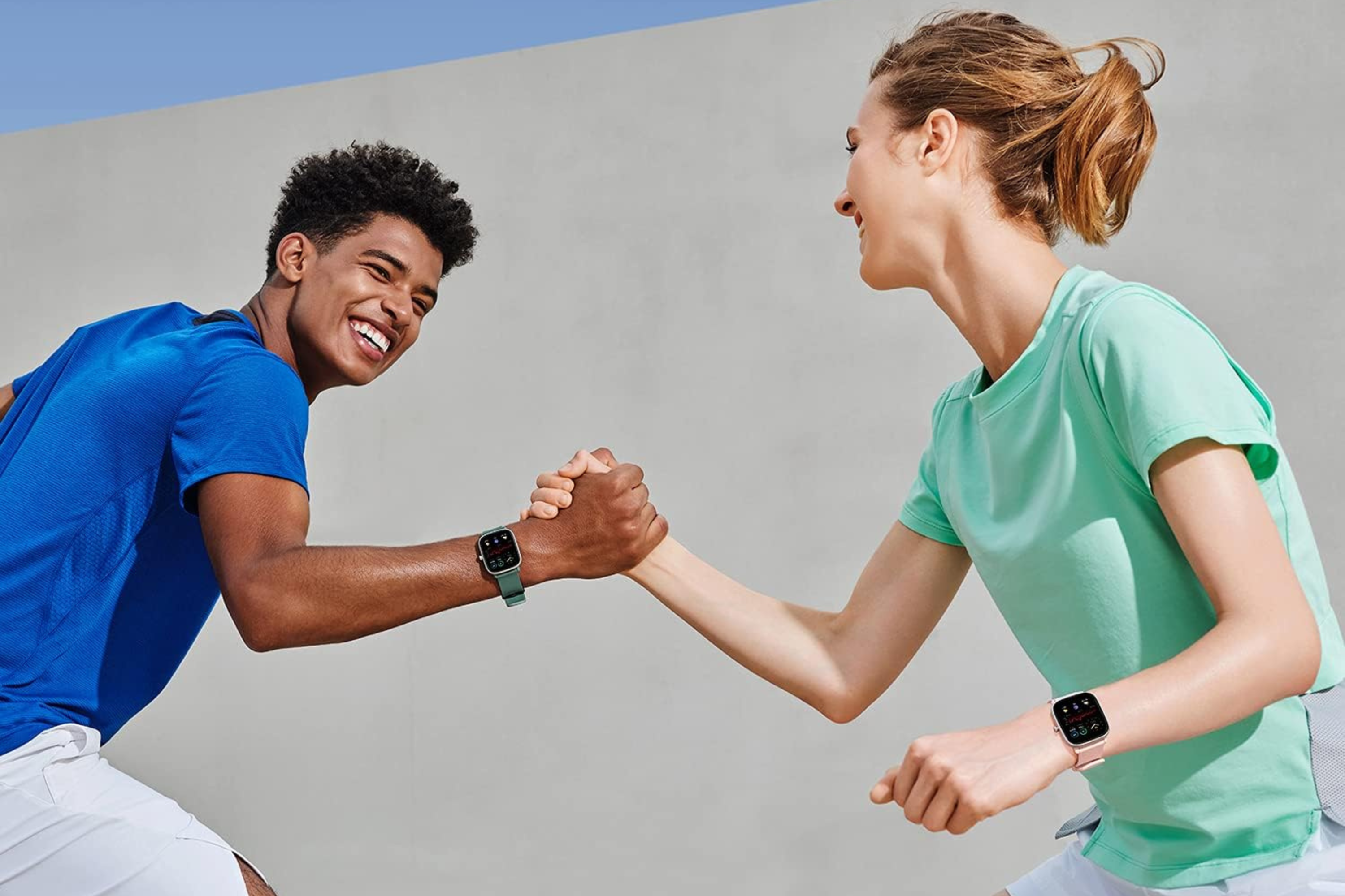 Amazfit GTS 2 Mini Smart Watch on write of two people arm wrestling 