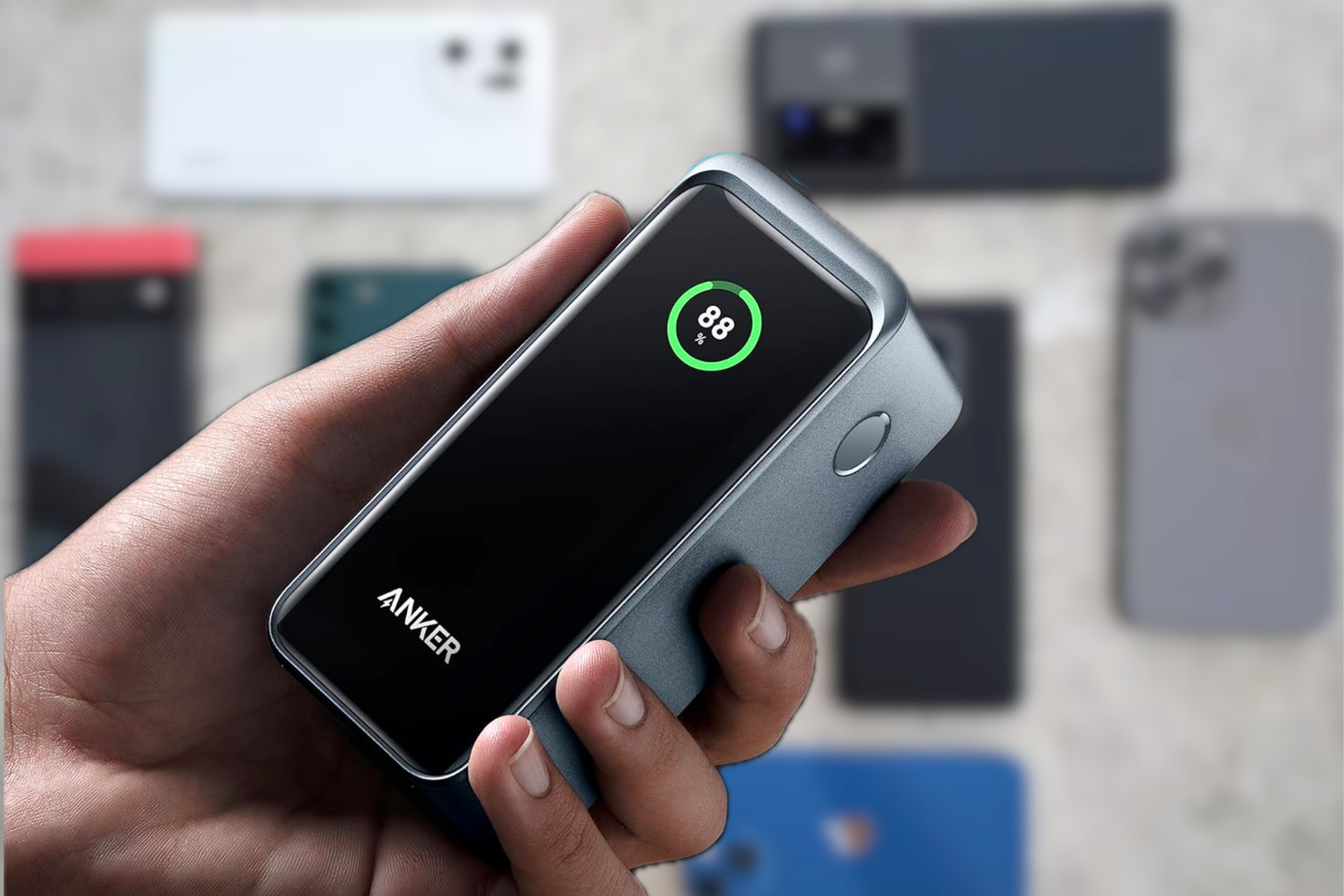  Anker Prime Power Bank in hand with phones in background
