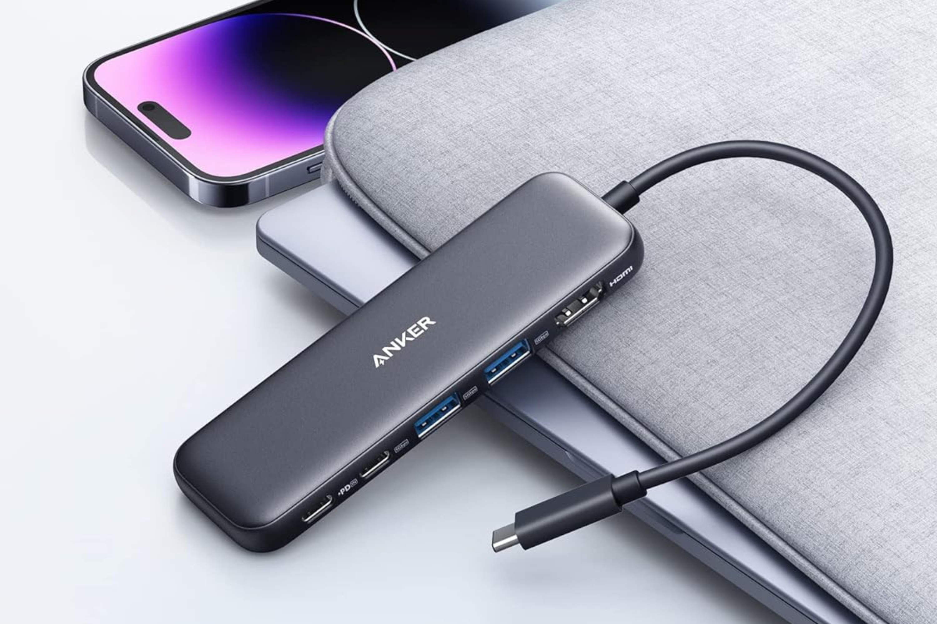 Anker 332 USB-C Hub on top of laptop next to smartphone