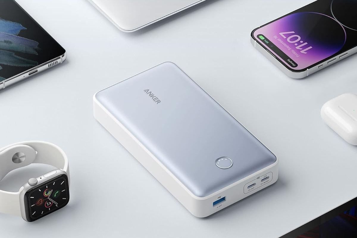 Anker 537 PowerCore 24K power bank in the center, surrounded by an iPhone, an Apple Watch, and other devices