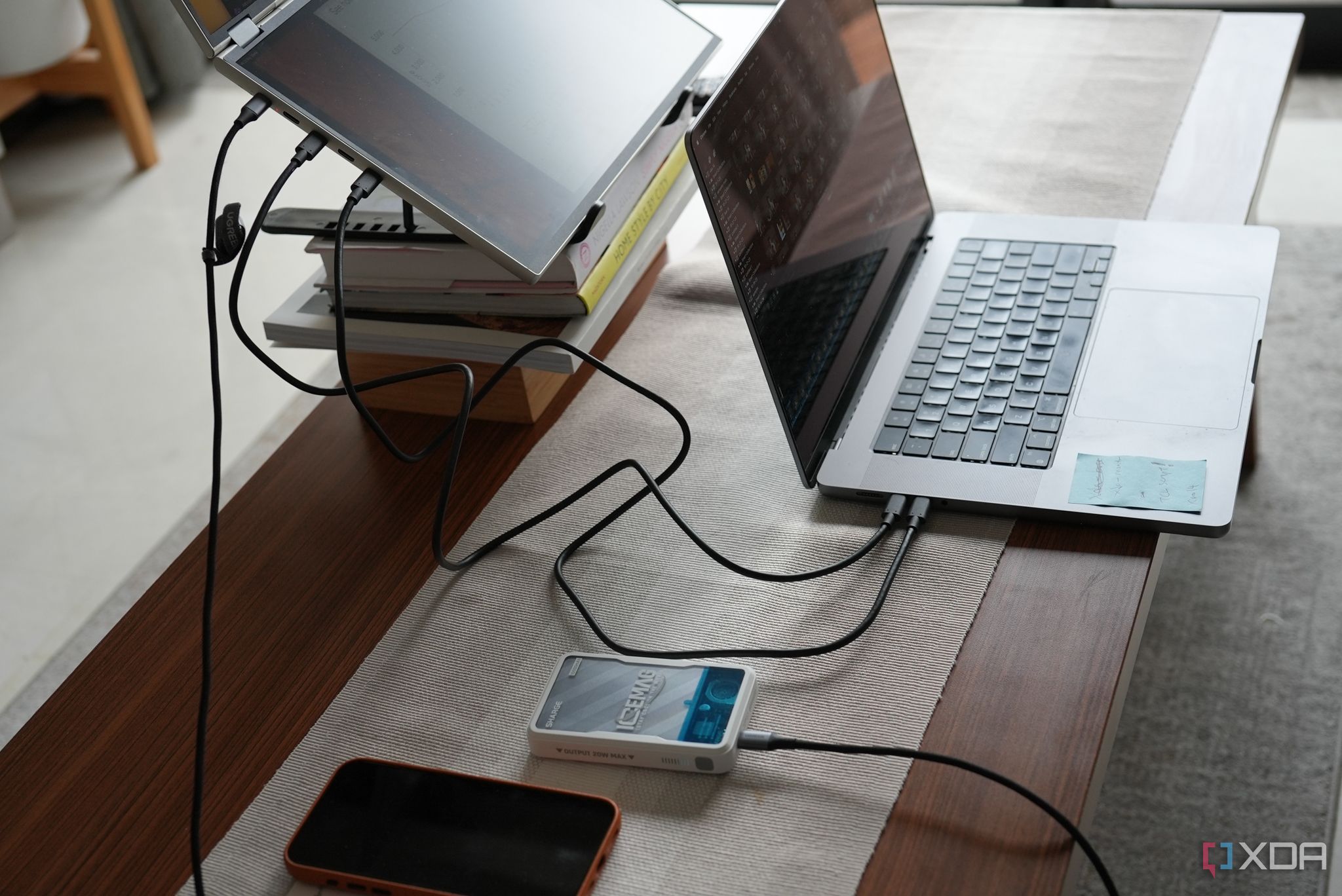 DuoOne on a desk with a laptop and phone