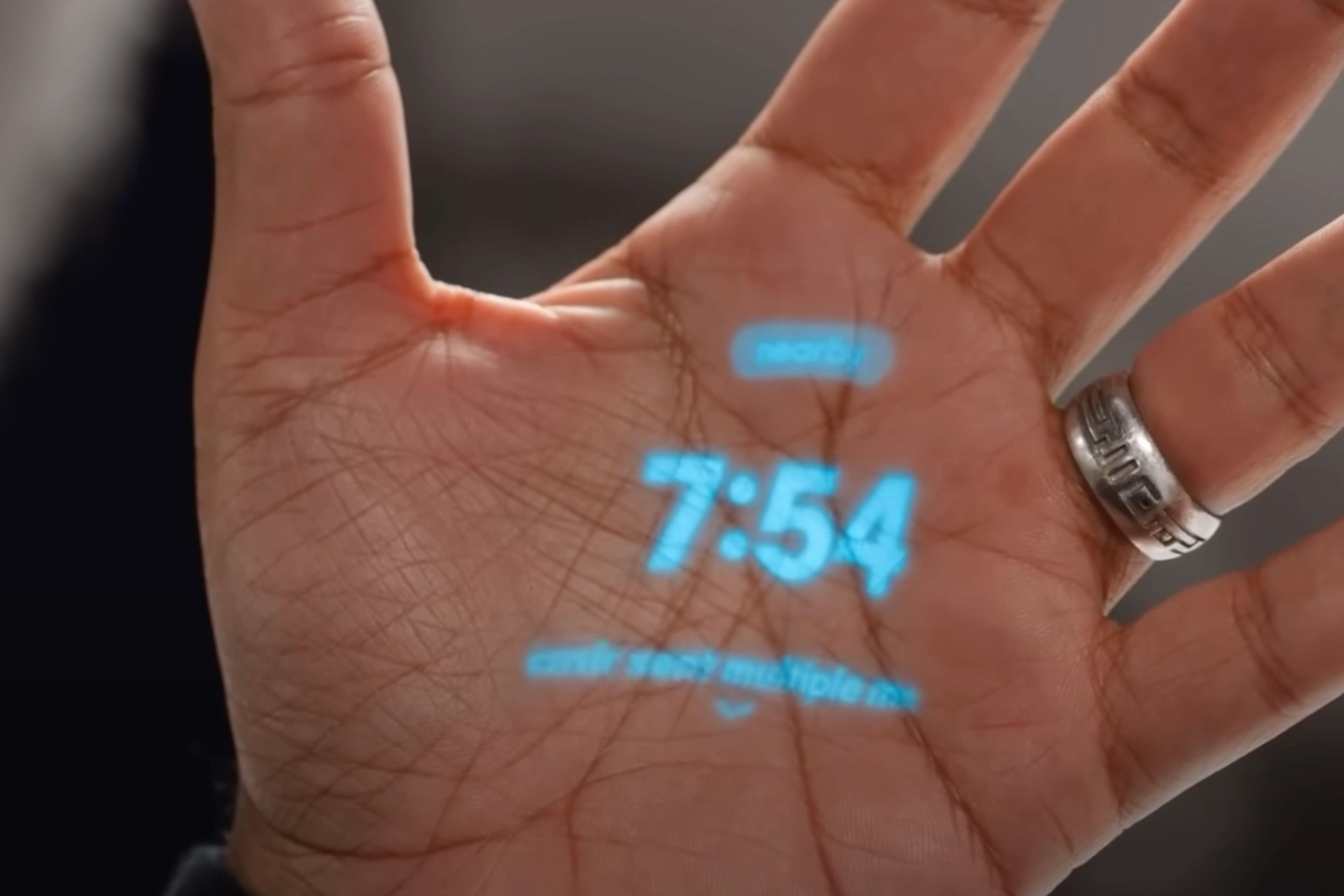 The Humane AI Pin's laser display on a hand. 