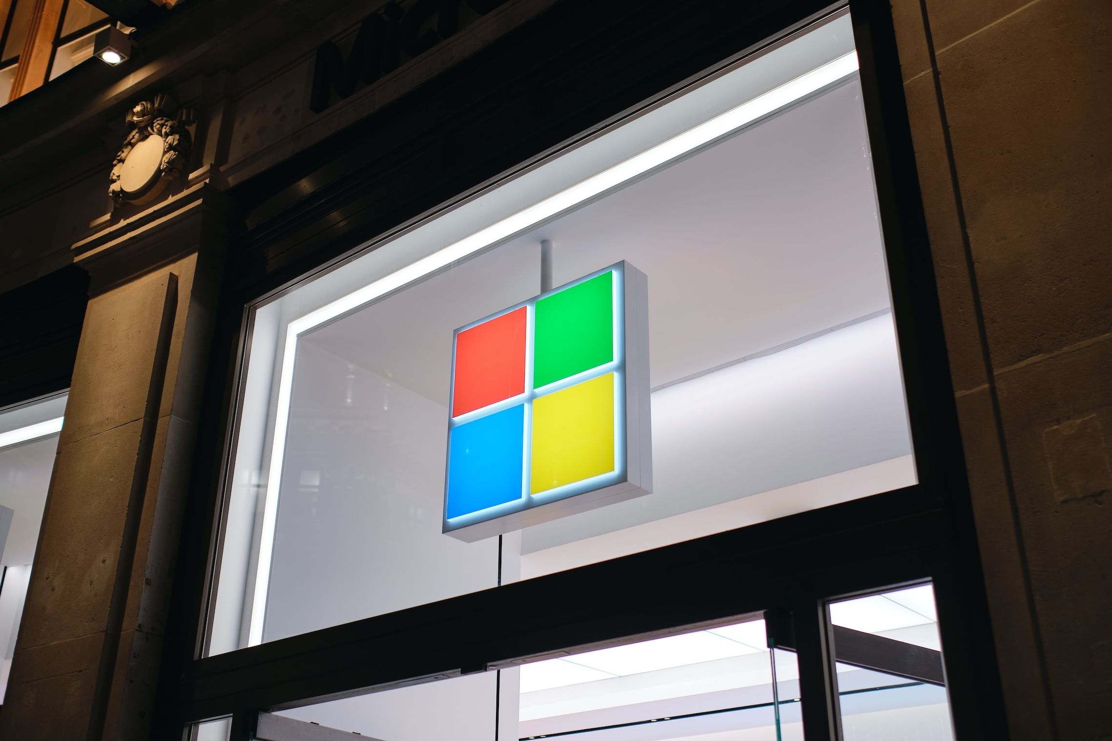 The Microsoft logo over a storefront.