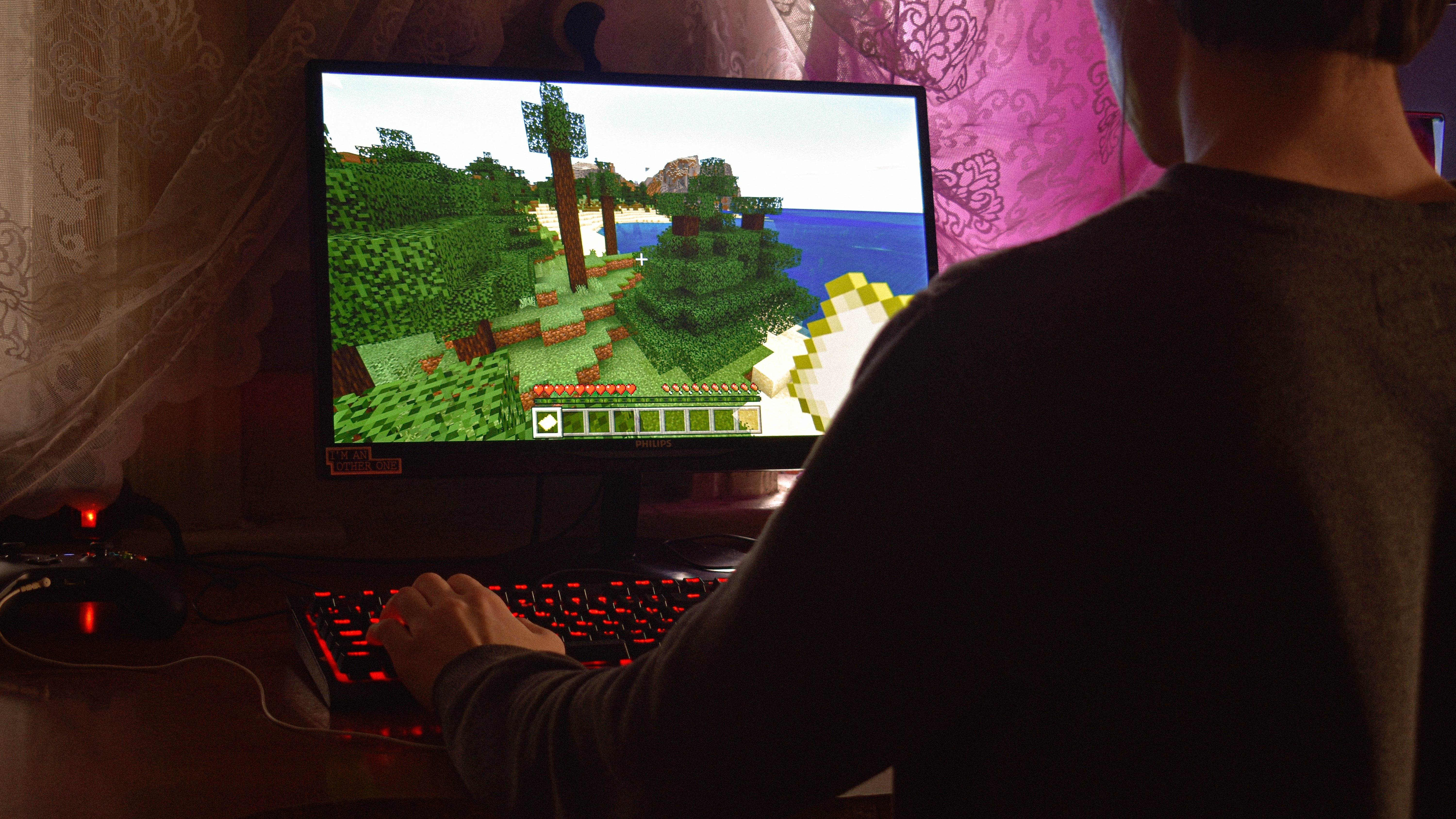 Man playing Minecraft on a PC