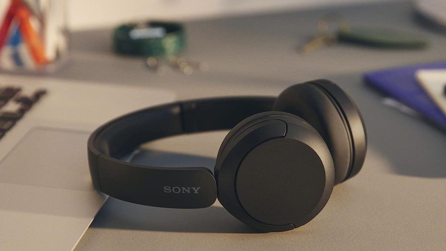 Sony WH-CH520L Wireless headphones on desk with blurred background