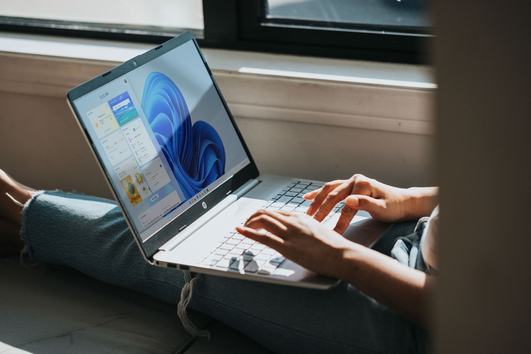 Someone using a laptop with Windows.