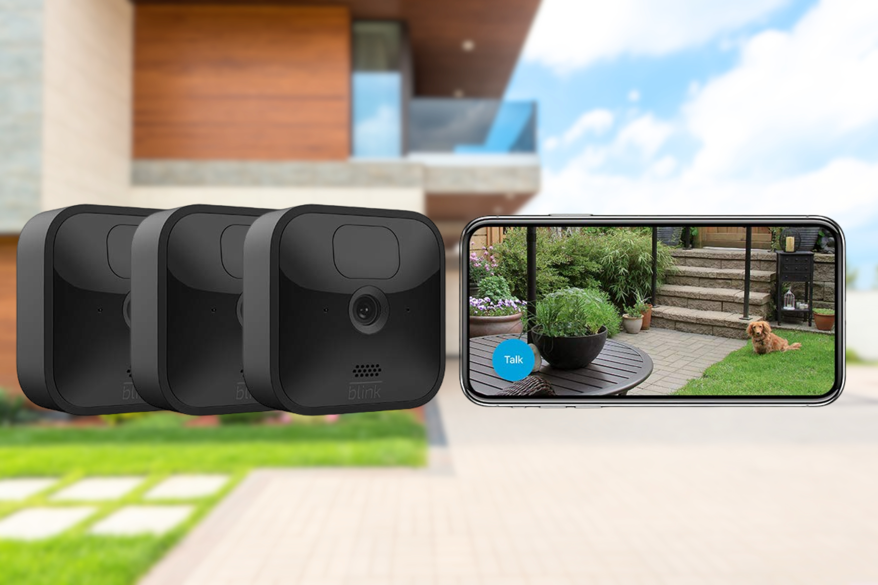 Blink outdoor camera with smartphone on blurred outdoor background 