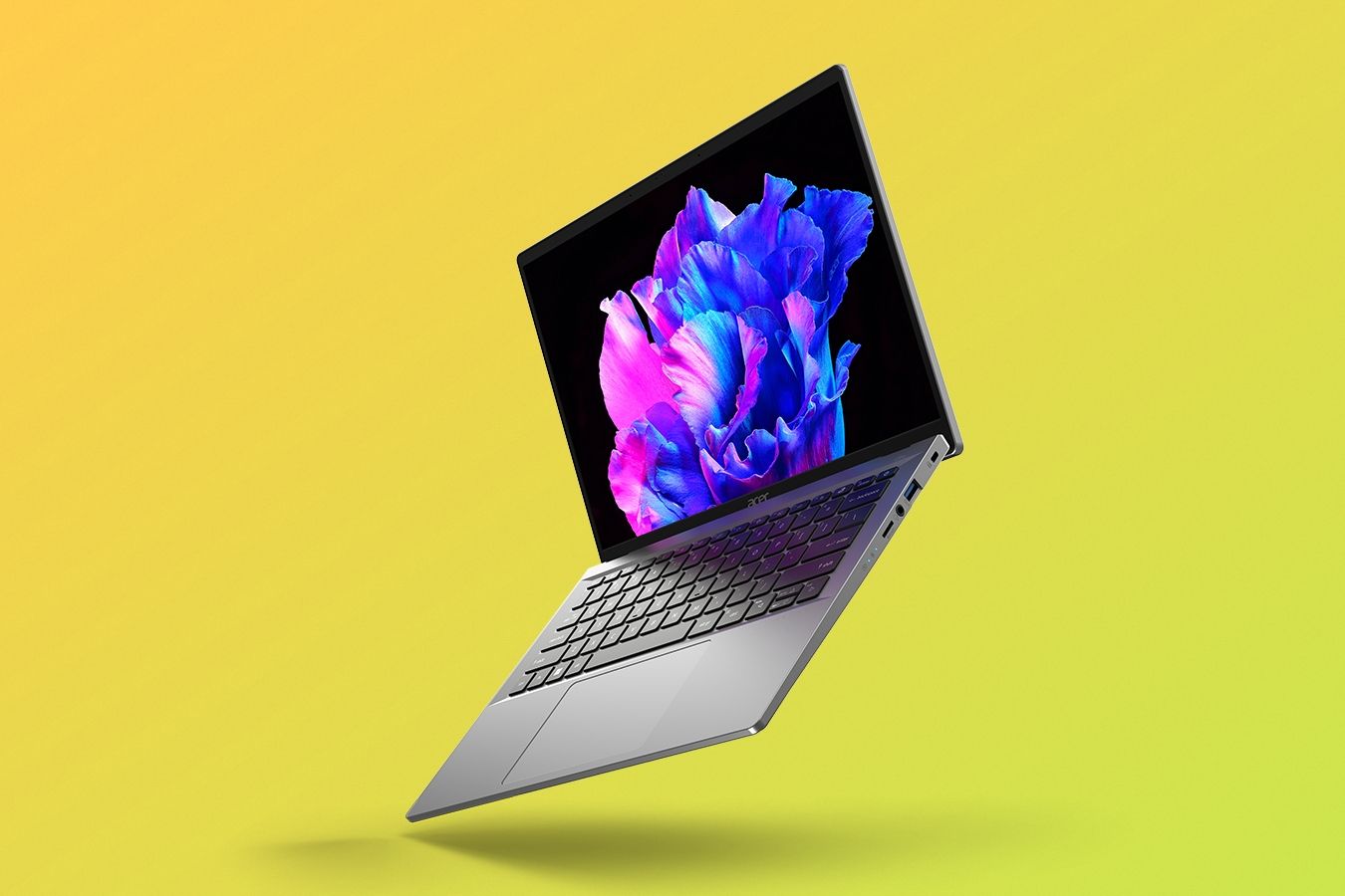 Angled front view of the Acer Swift Go 14 over a yellow and green gradient
