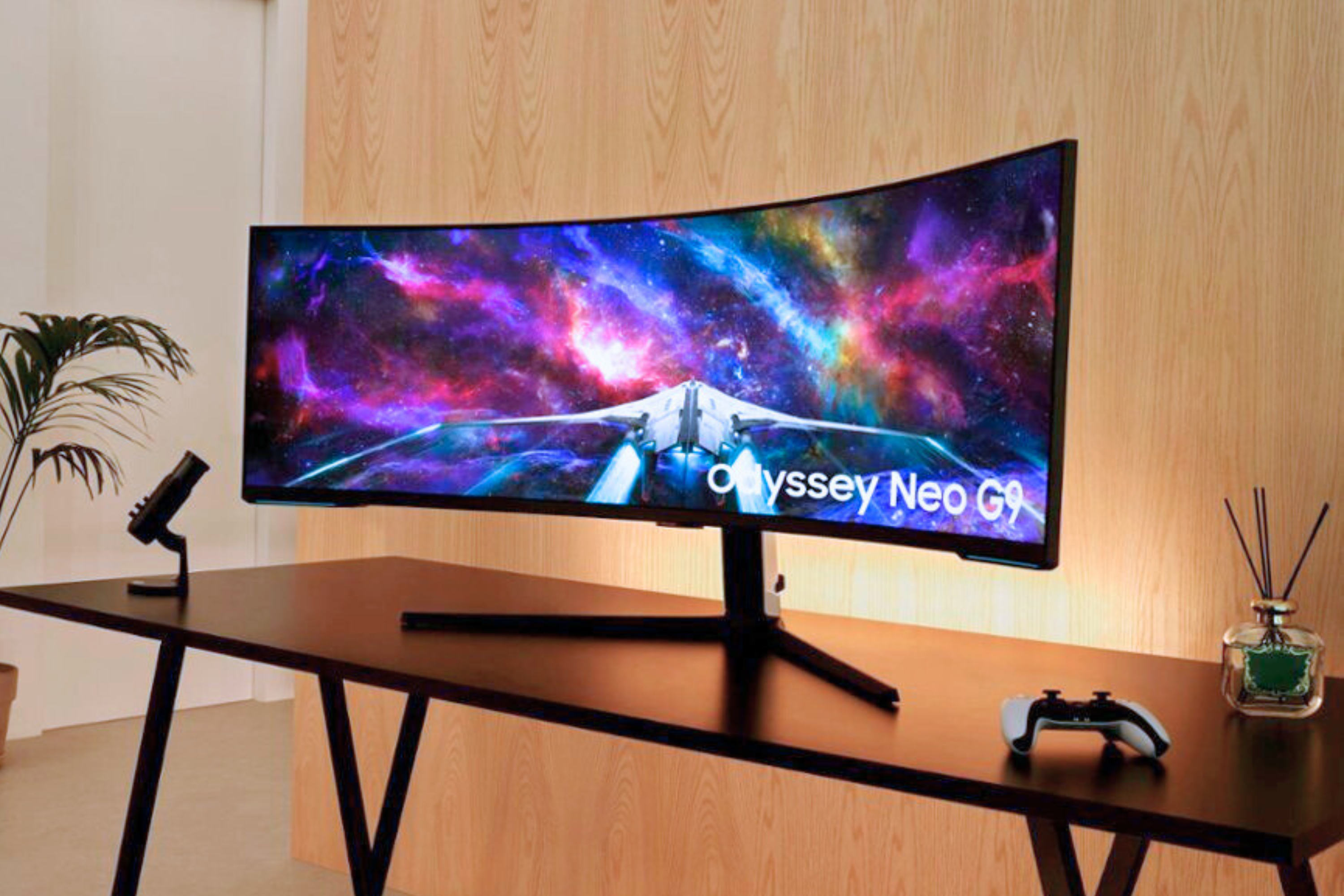 SAMSUNG 57-inch Odyssey Neo G9 Series Dual 4K UHD 1000R Curved Gaming Monitor on desk in front of light