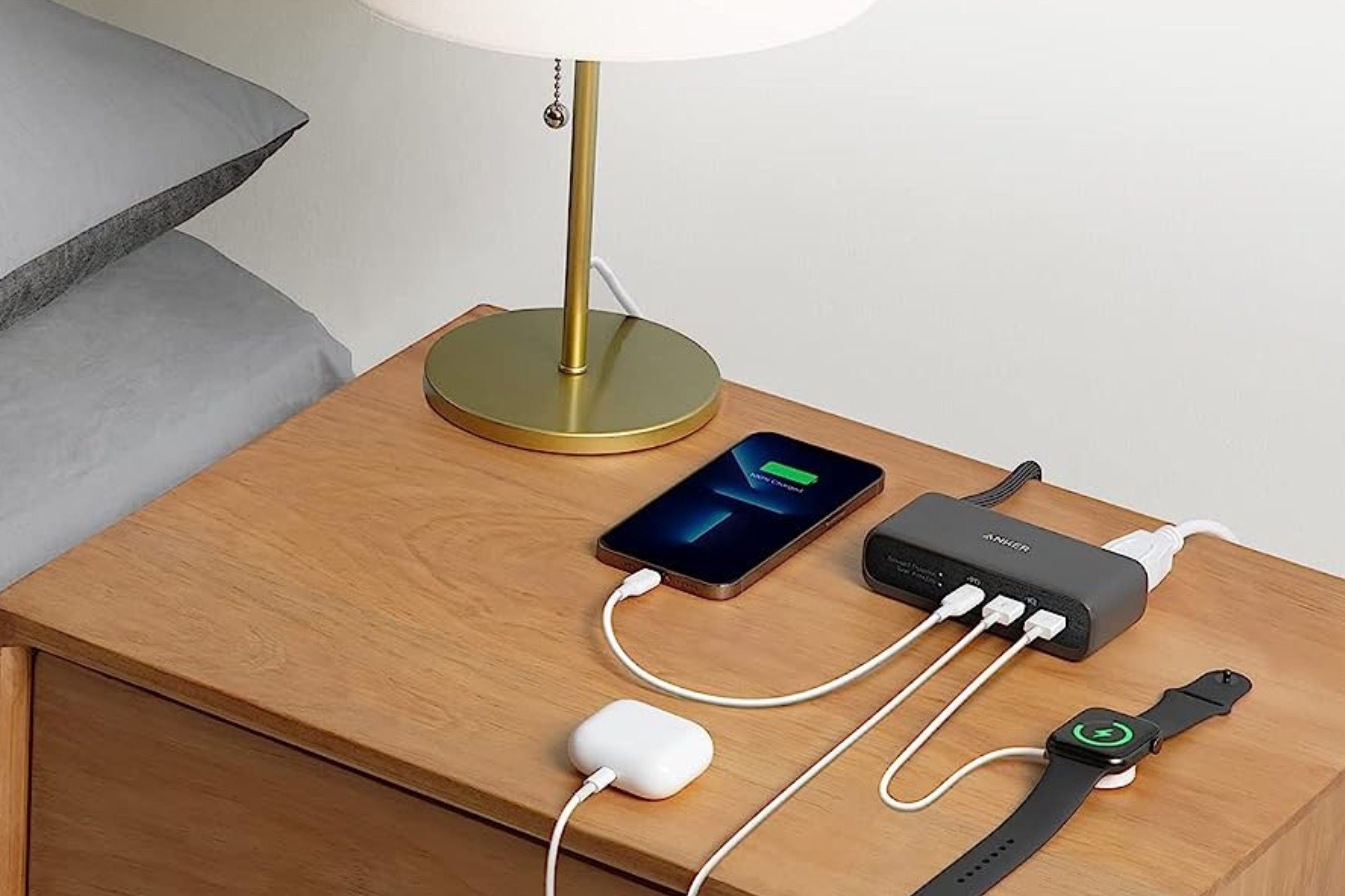 Anker 521 Charging Station with iPhone, Apple Watch, and AirPods plugged in