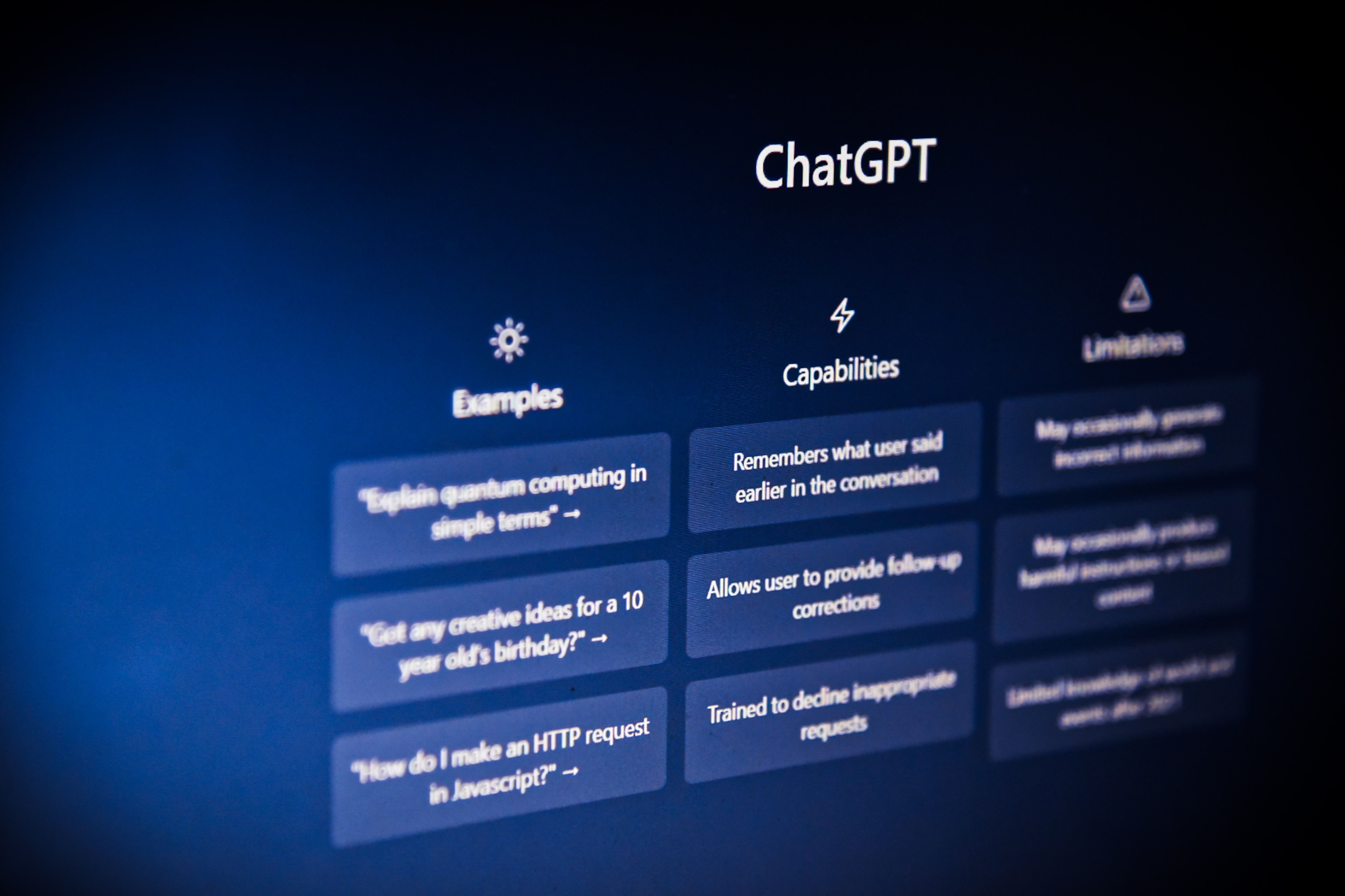 An angled photo of a screen showing ChatGPT's prompt and capabilities.