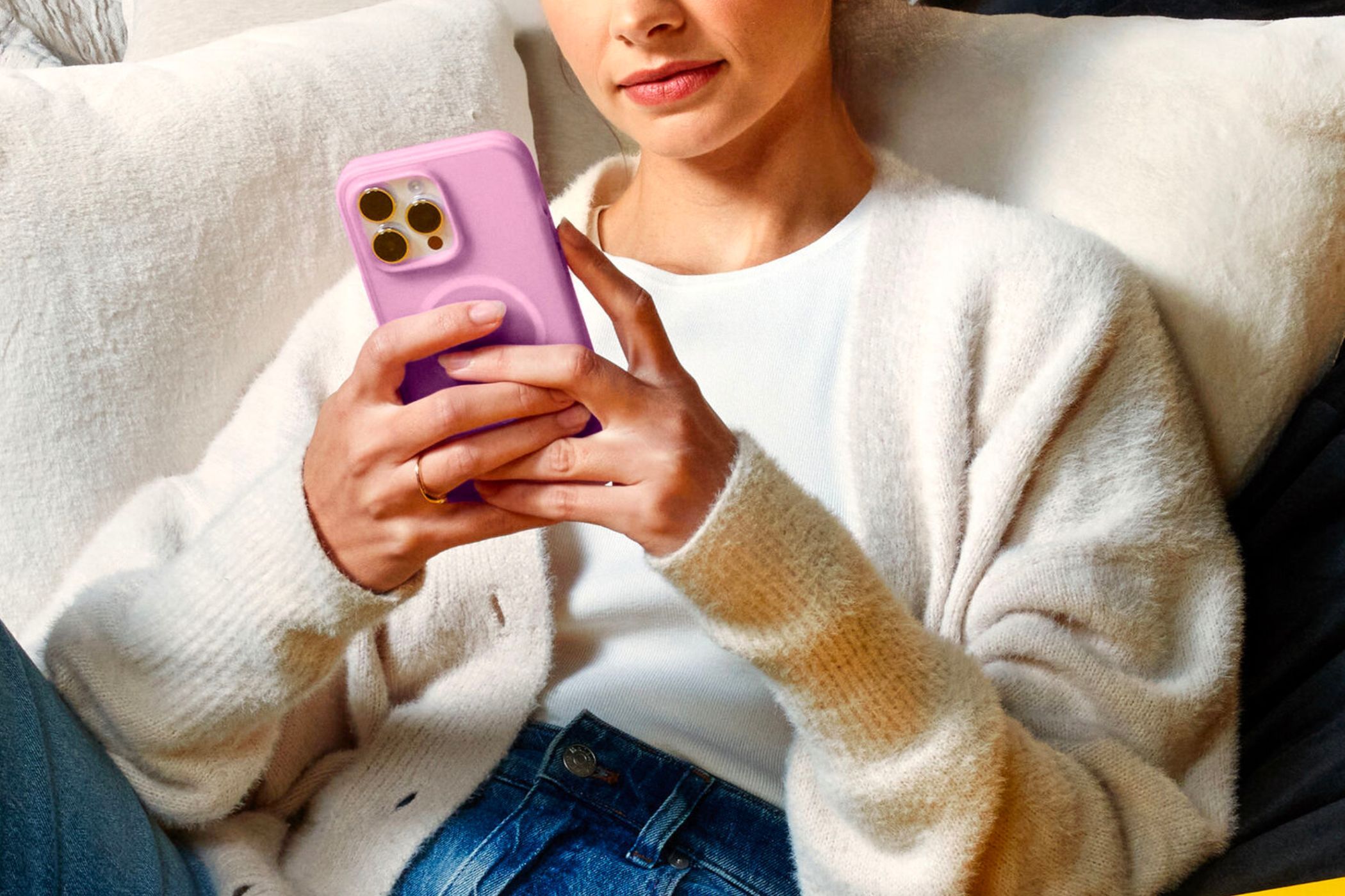 An image showing a person holding an iPhone 15 Pro with an Otterbox iPhone case in their hand. 
