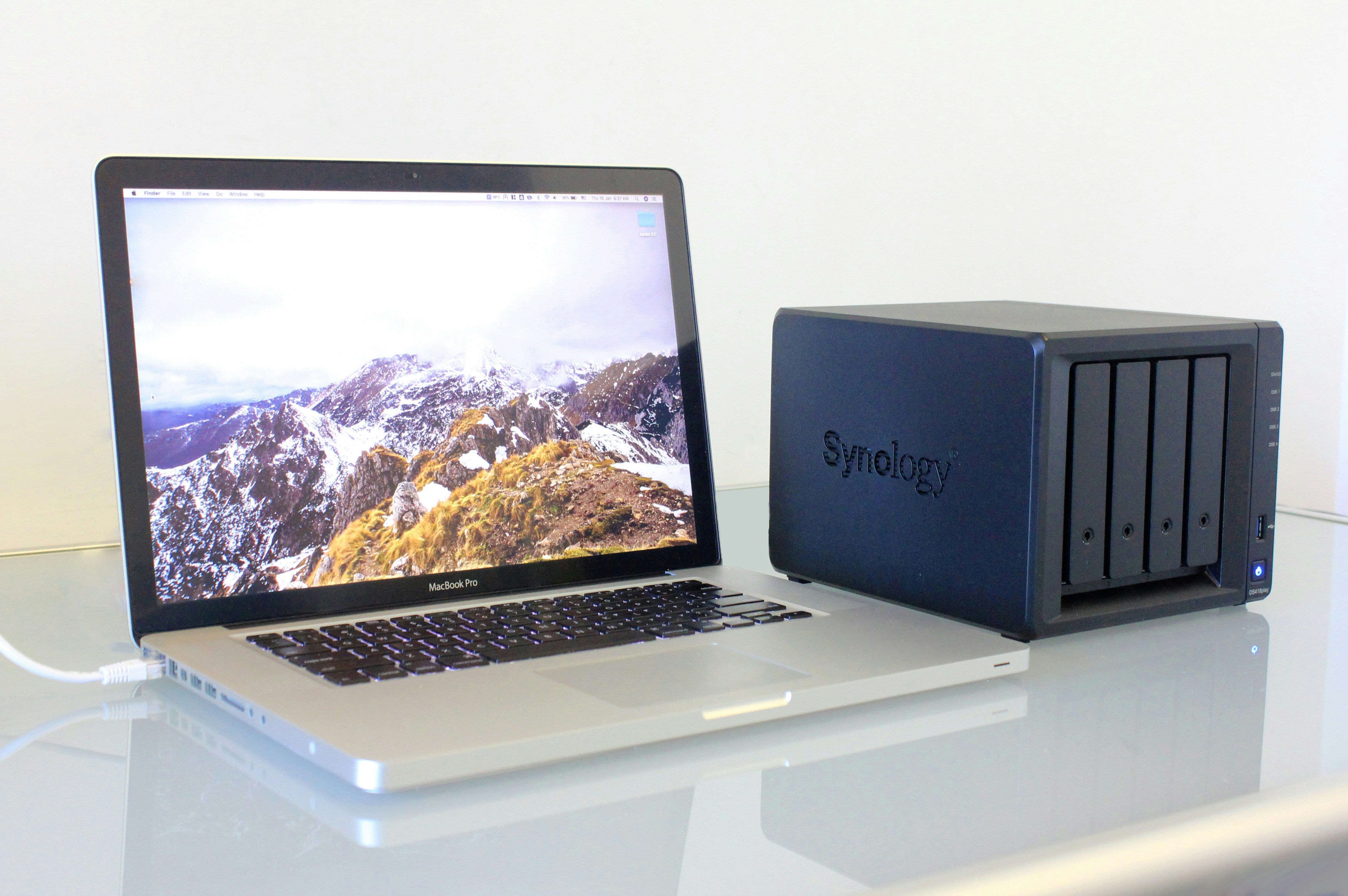 Photo of a MacBook Pro connected to a Synology NAS.
