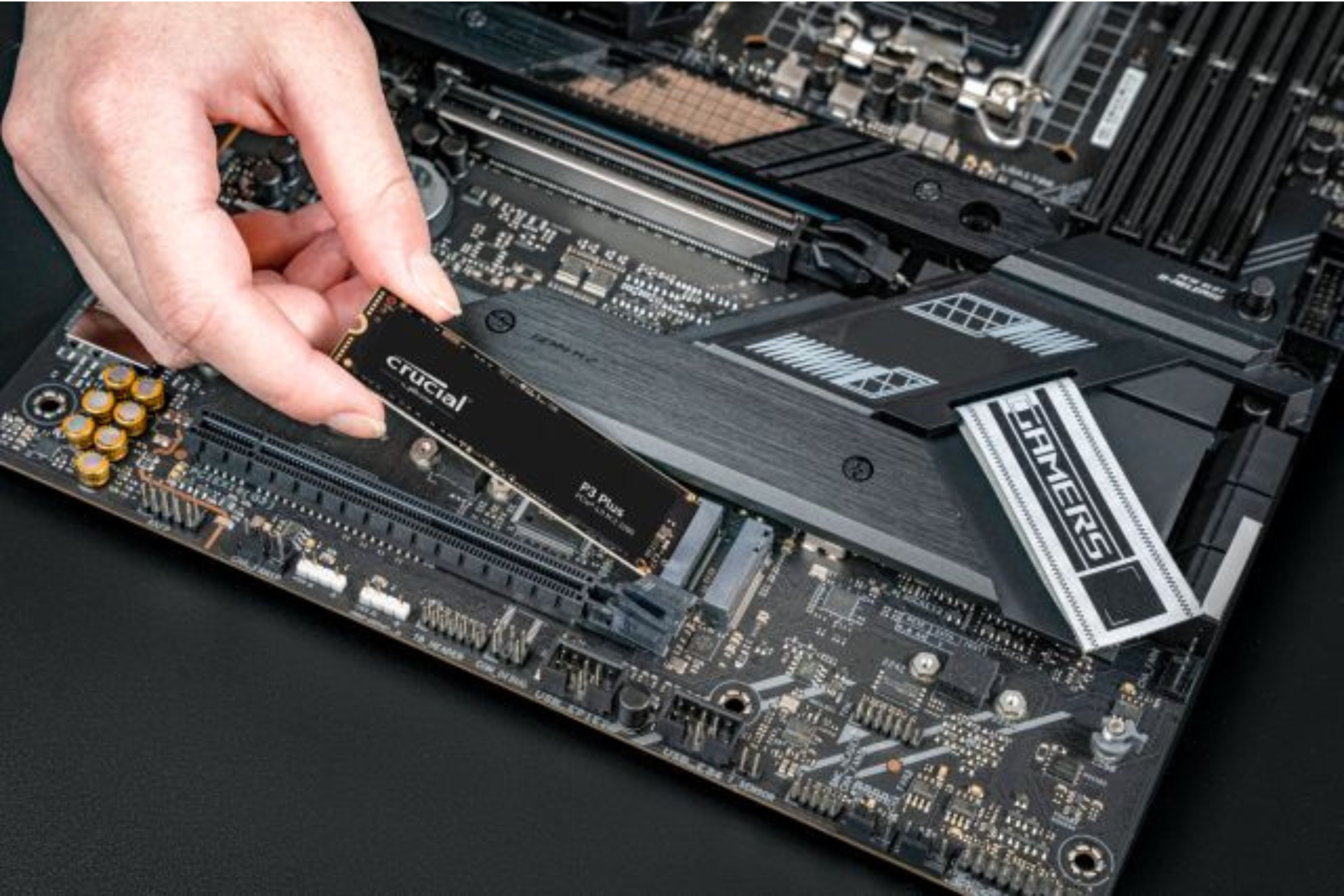 Crucial P3 Plus SSD being installed into a motherboard