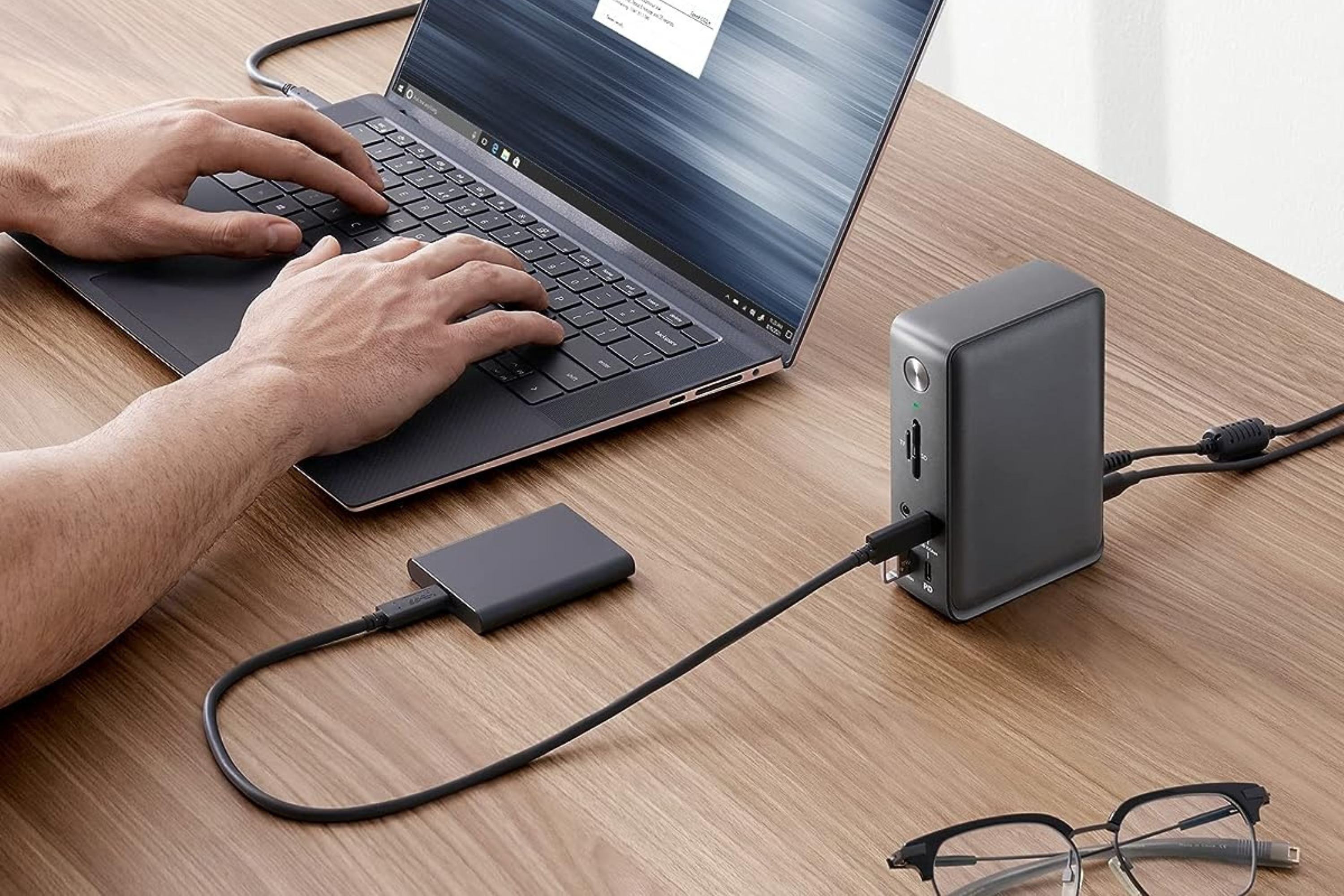 Anker 575 docking station on table plugged into portable SSD