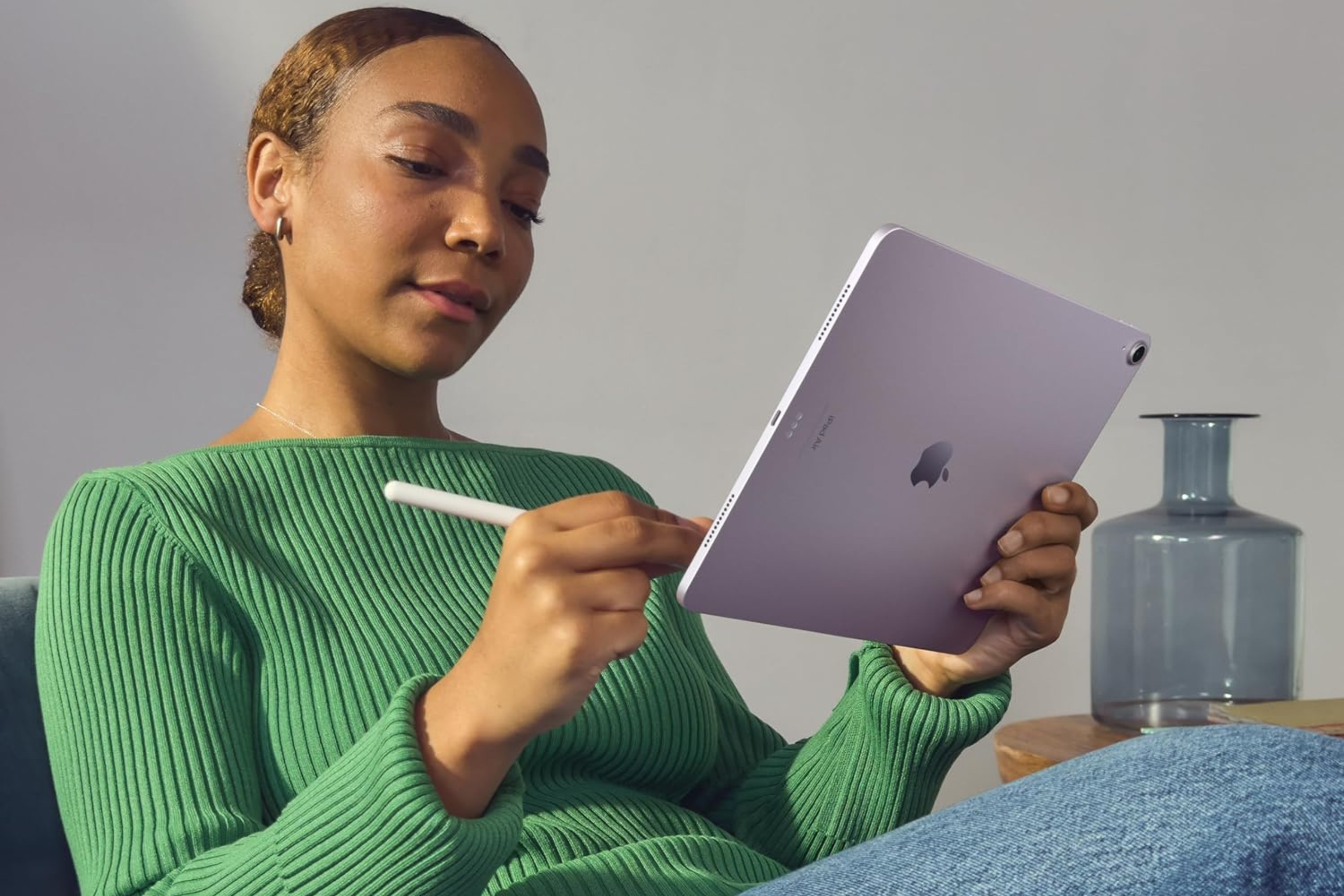 Person holding Apple iPad Air with stylus