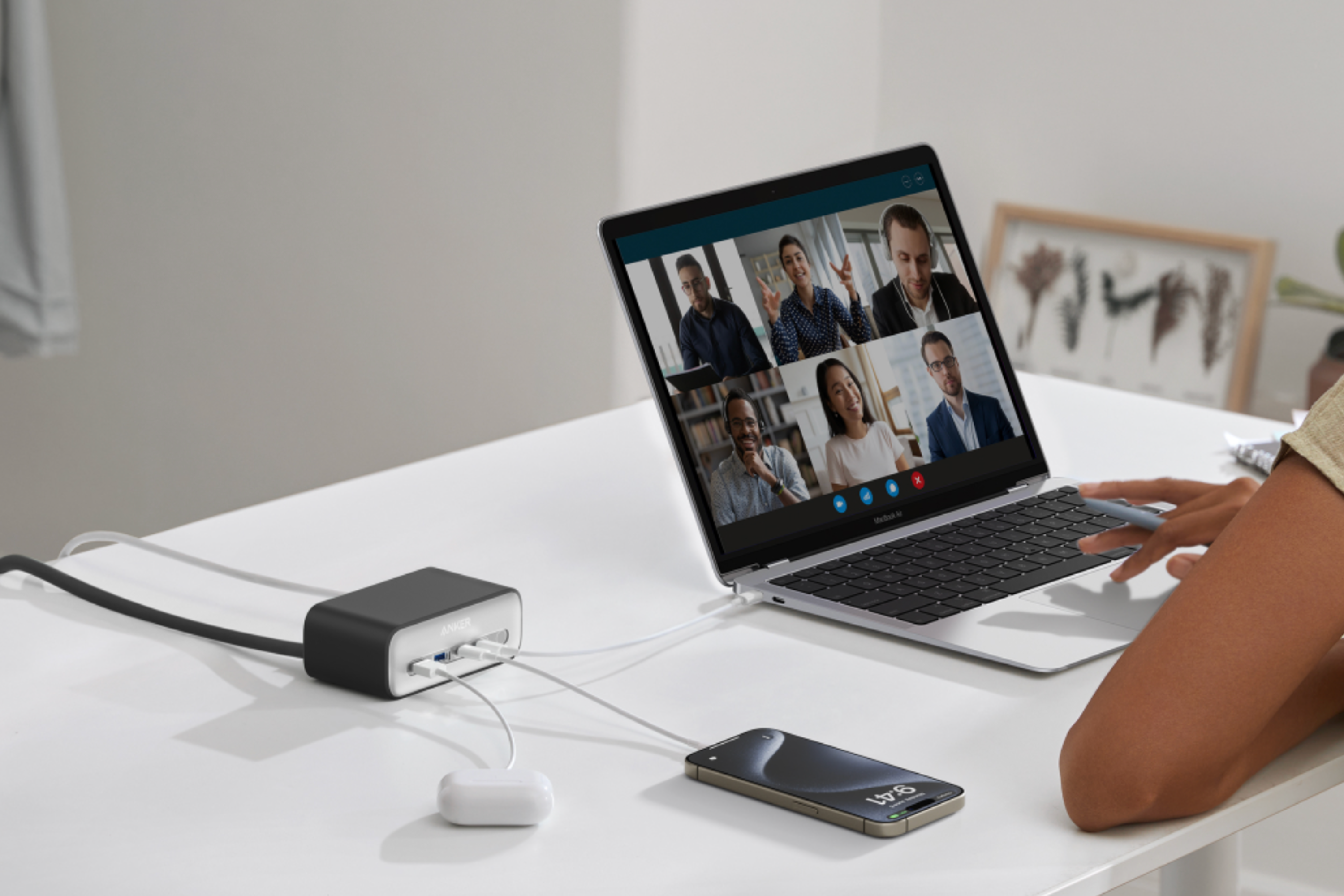 Anker 525 Charging Station on desk connected to laptop, smartphones and earbuds