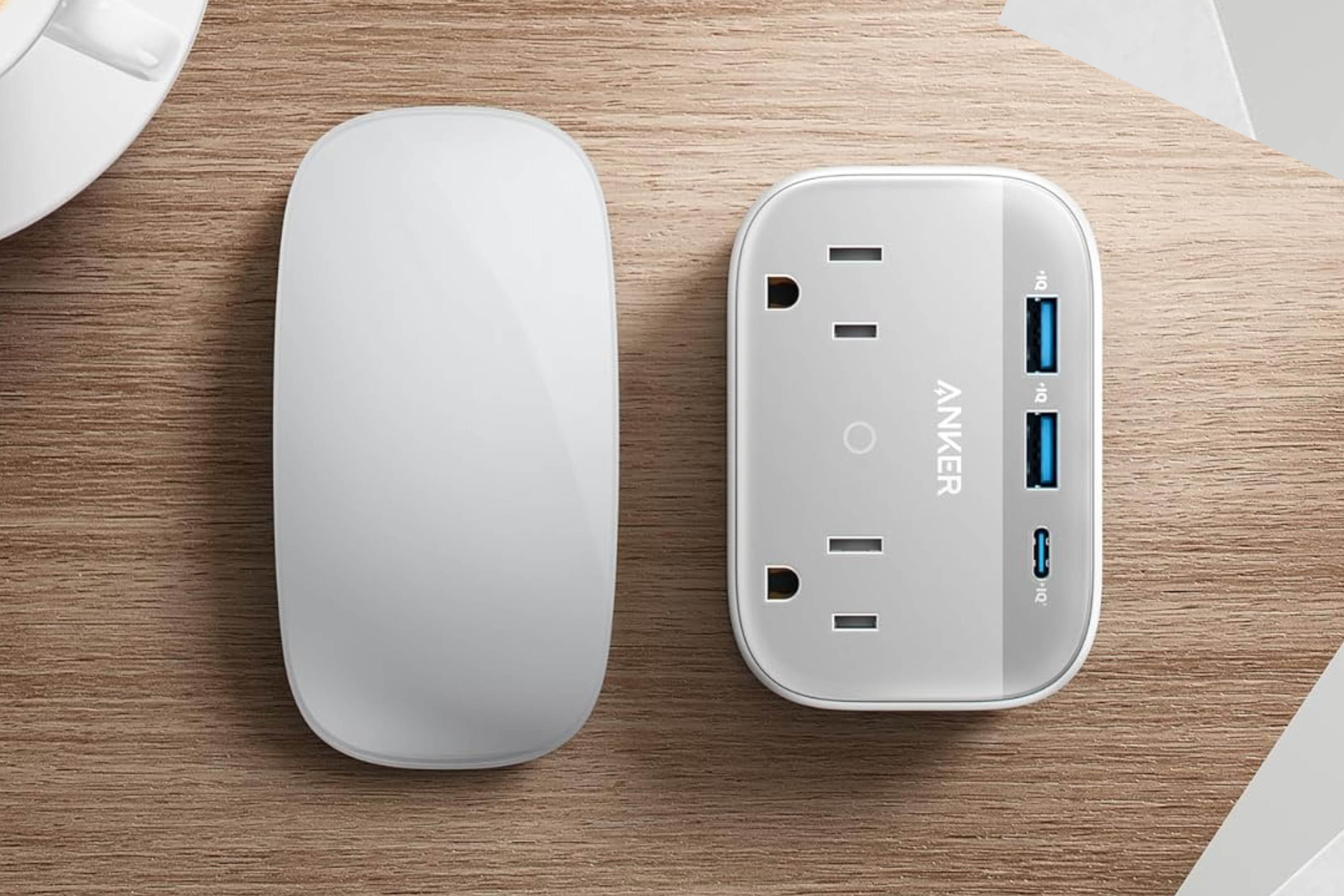 Anker Portable Outlet Extender with Foldable Plug on desk next to mouse
