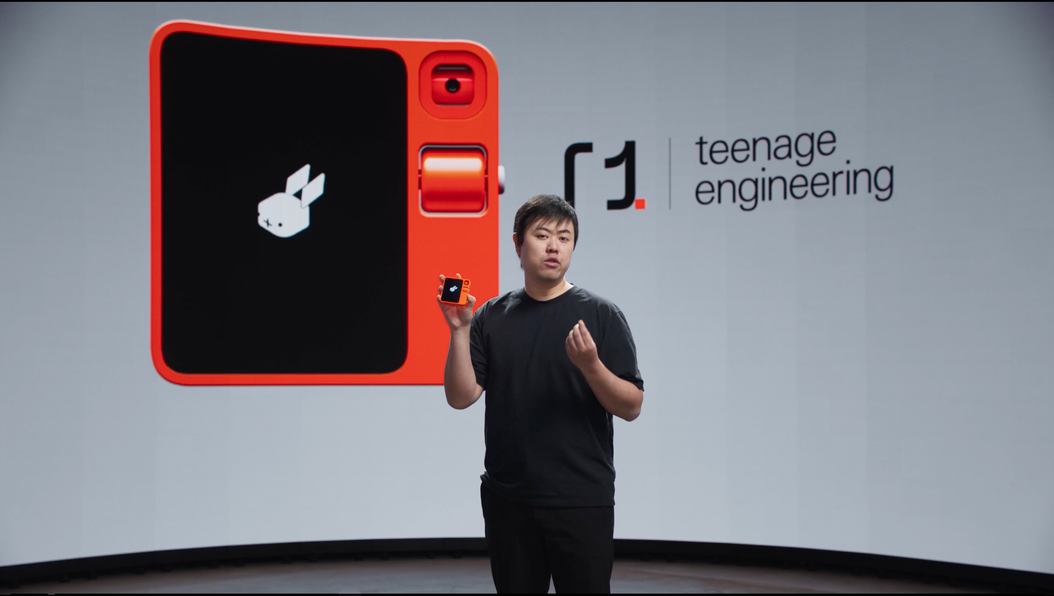 Jesse Lyu holding the Rabbit R1, designed in collaboration between Rabbit and Teenage Engineering