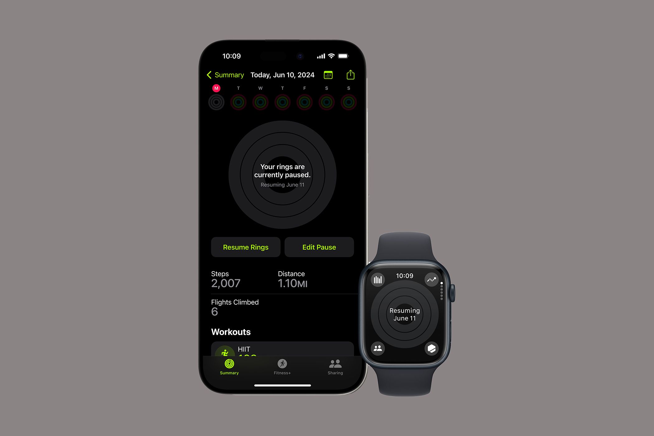 An Apple Watch beside an iPhone showing that Activity Rings are paused.