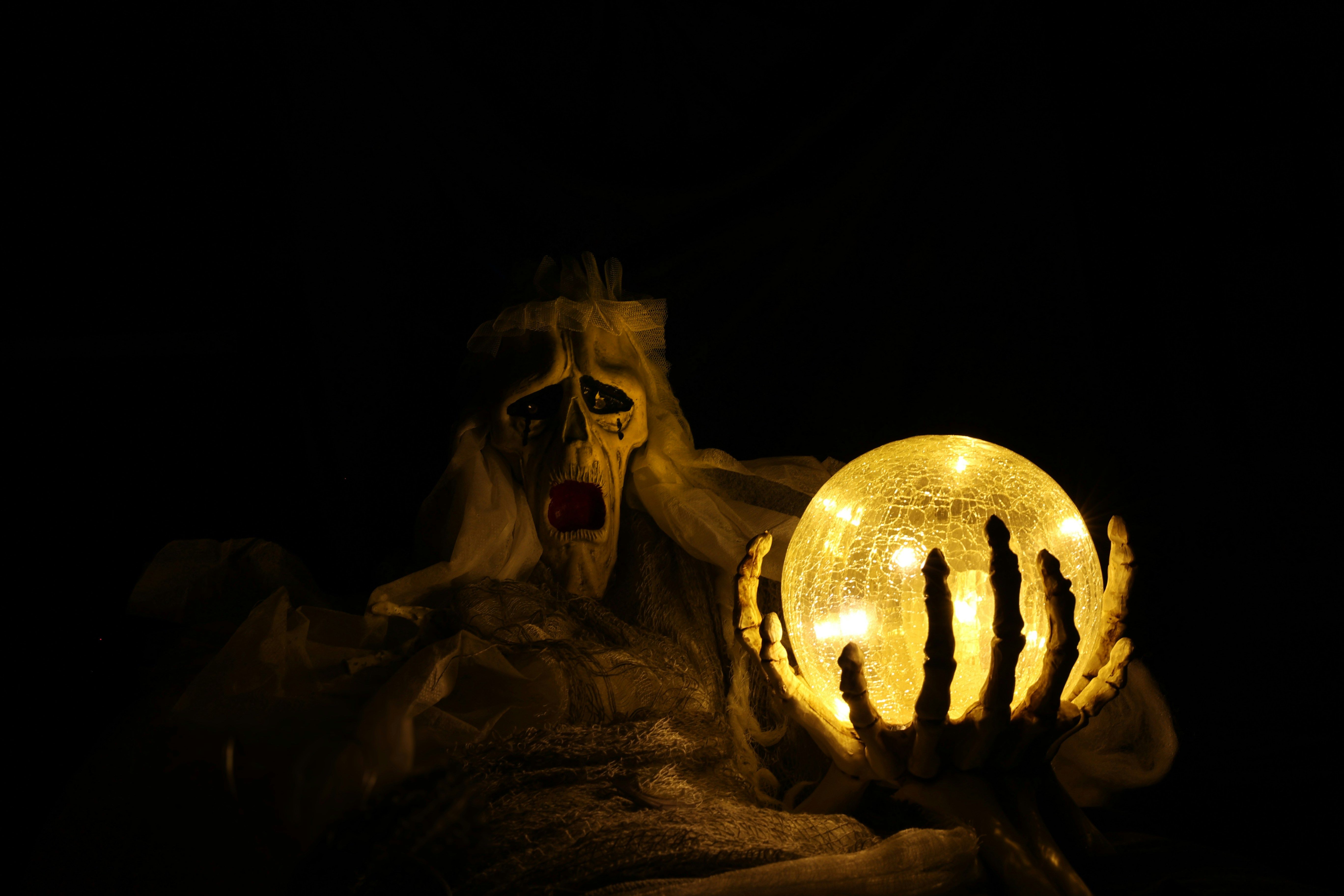 Ghost holding a glowing globe.