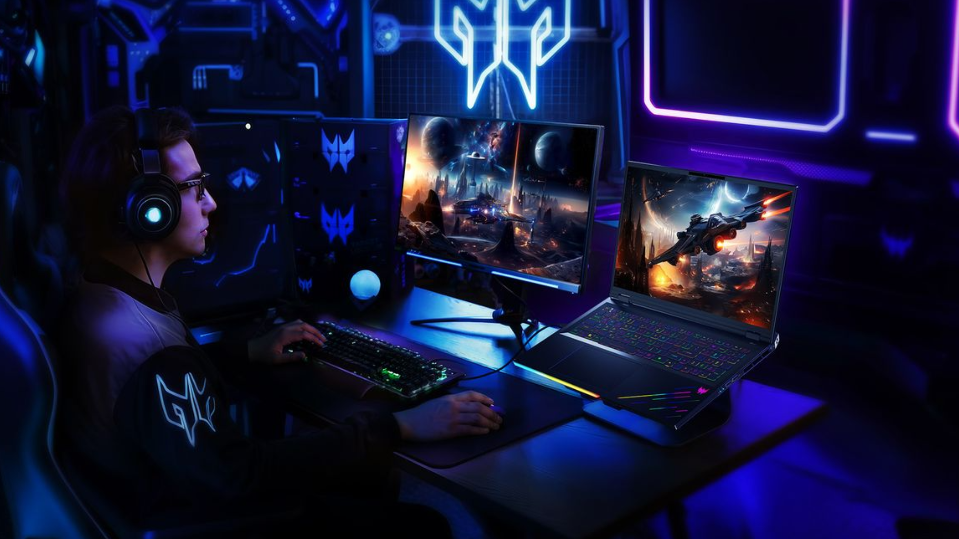 Una persona juega con una computadora portátil y un monitor Acer Predator Helios en una habitación oscura