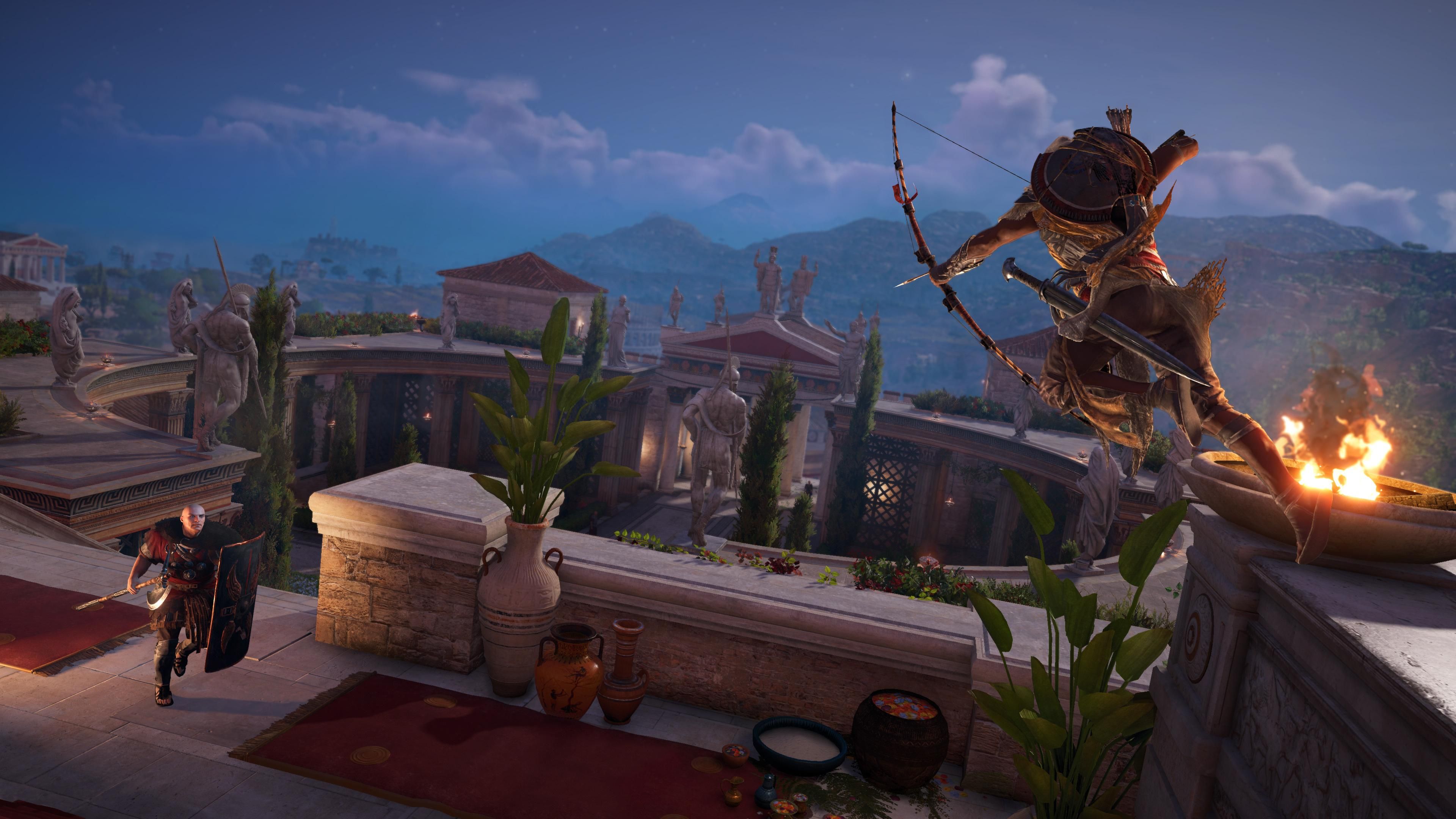 Bayek jumping from a ledge and aiming a bow at a soldier with a shield