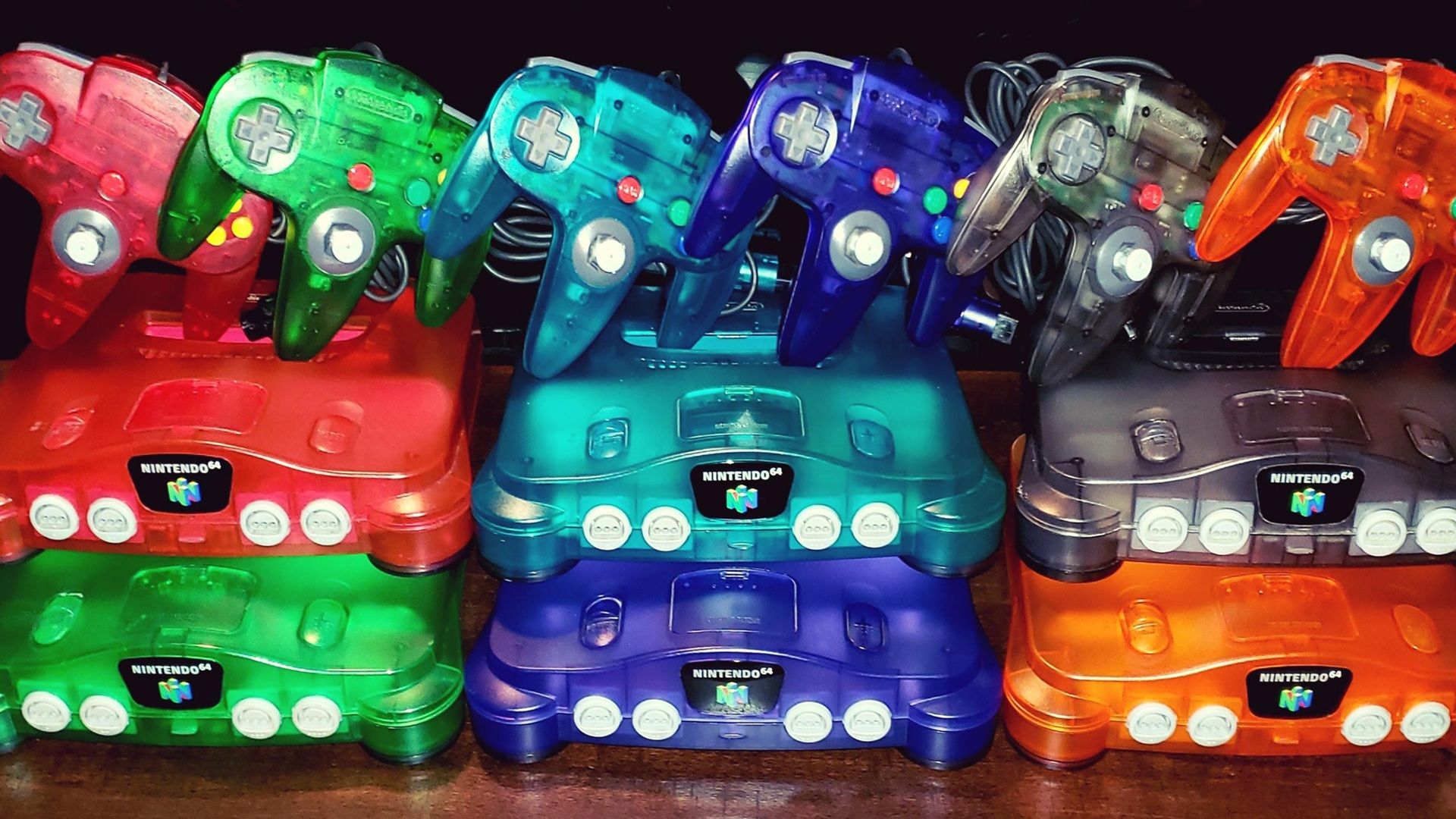 A picture of different colored Nintendo 64 consoles
