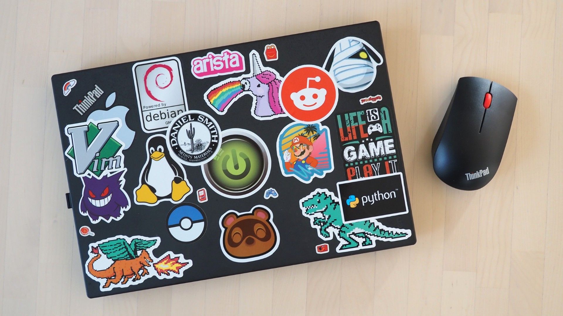 The lid of Jessica Nicholson's X270 filled with various logo stickers.