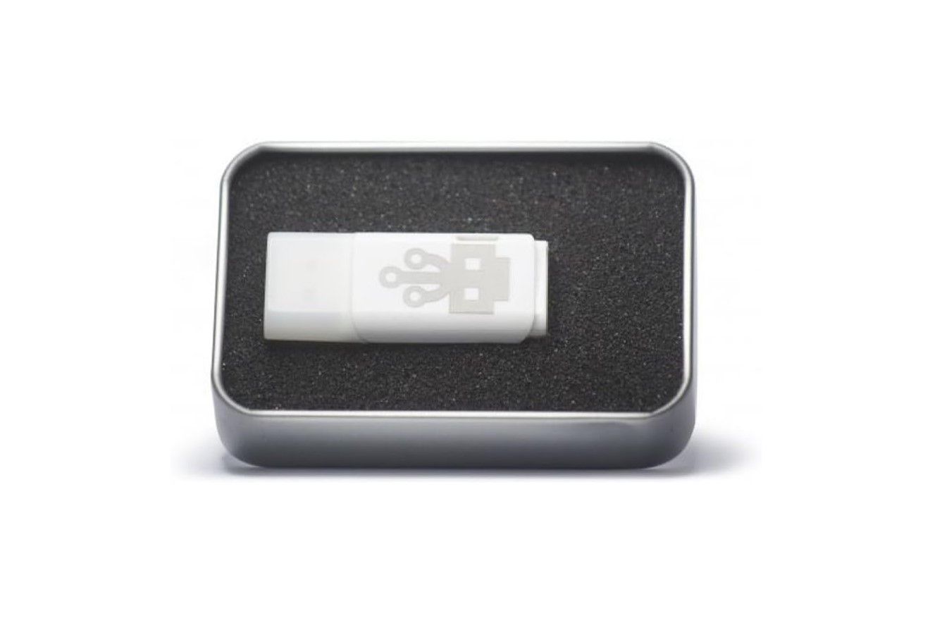 A white USB stick placed on a black case