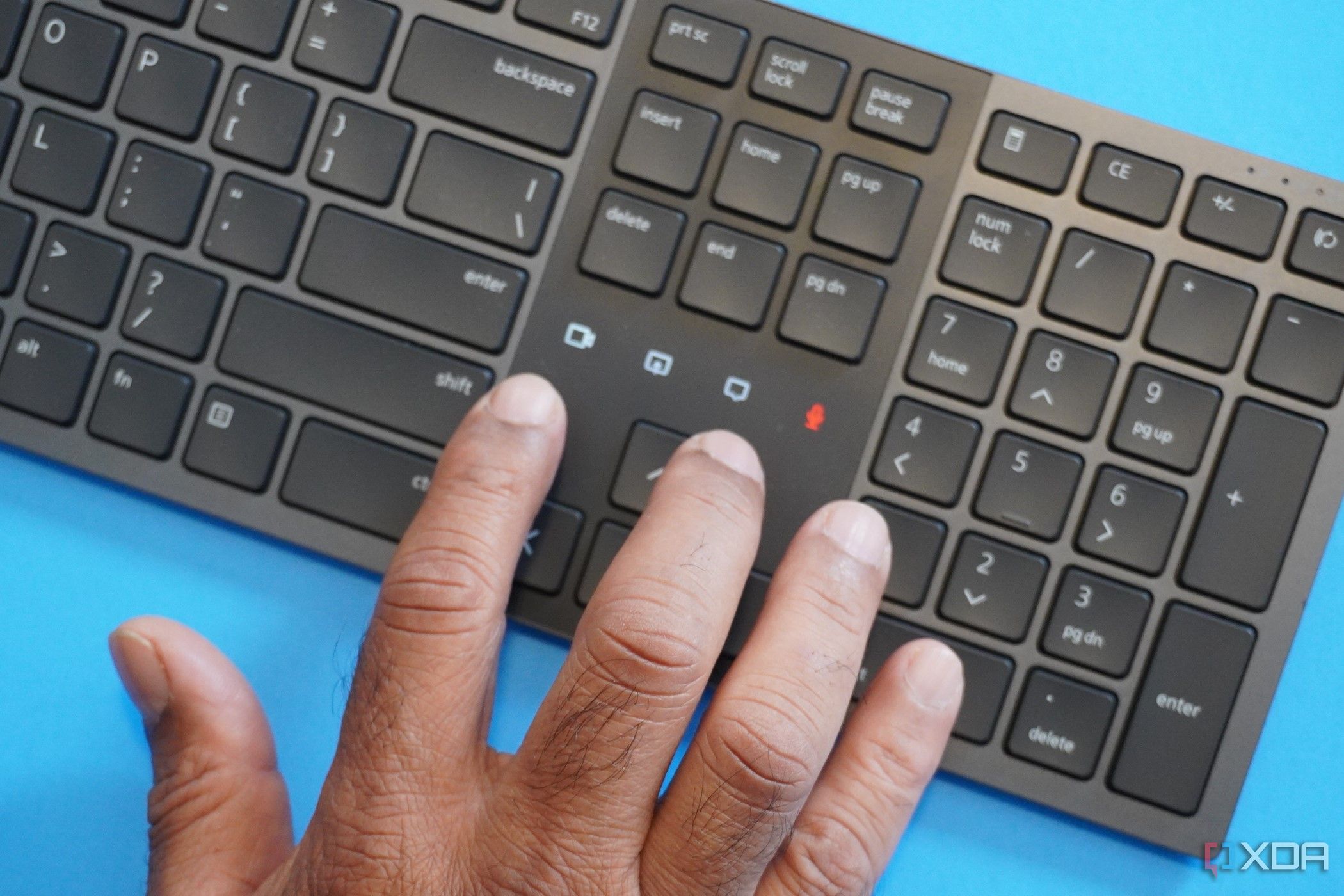 A man pointing out the Collaboration lights on the Dell Premier Collaboration Keyboard