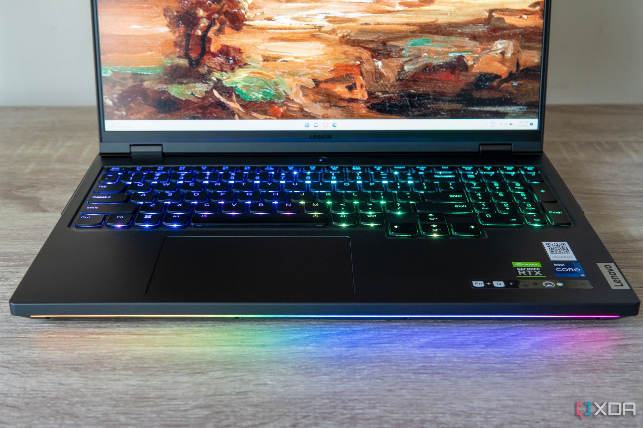 Front view of the Lenovo Legion Pro 7i Gen 8 with an RGB keyboard and light bar displaying rainbow colors