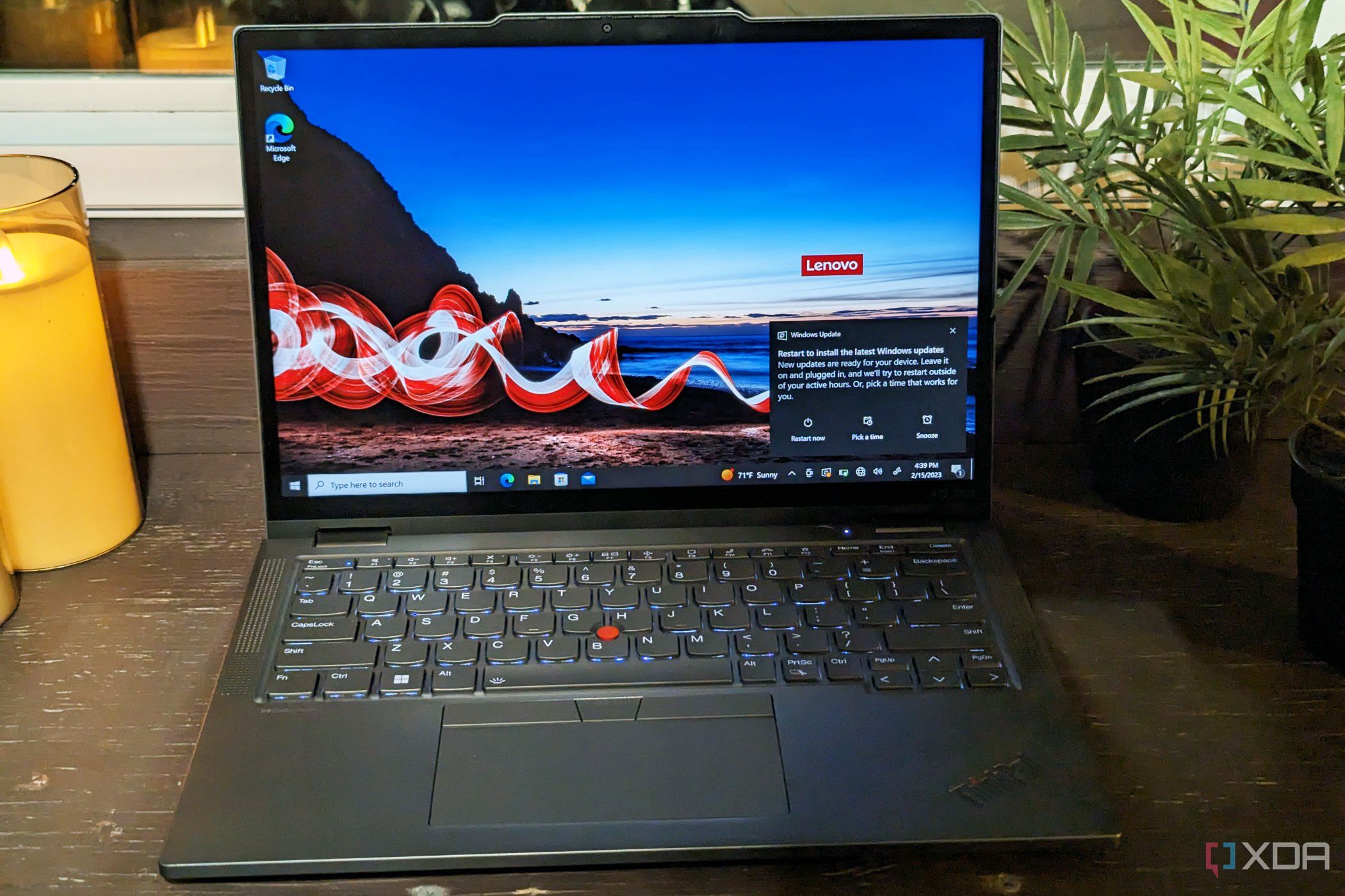 Lenovo ThinkPad X13 Yoga Gen 4 on a desk with candles in the back