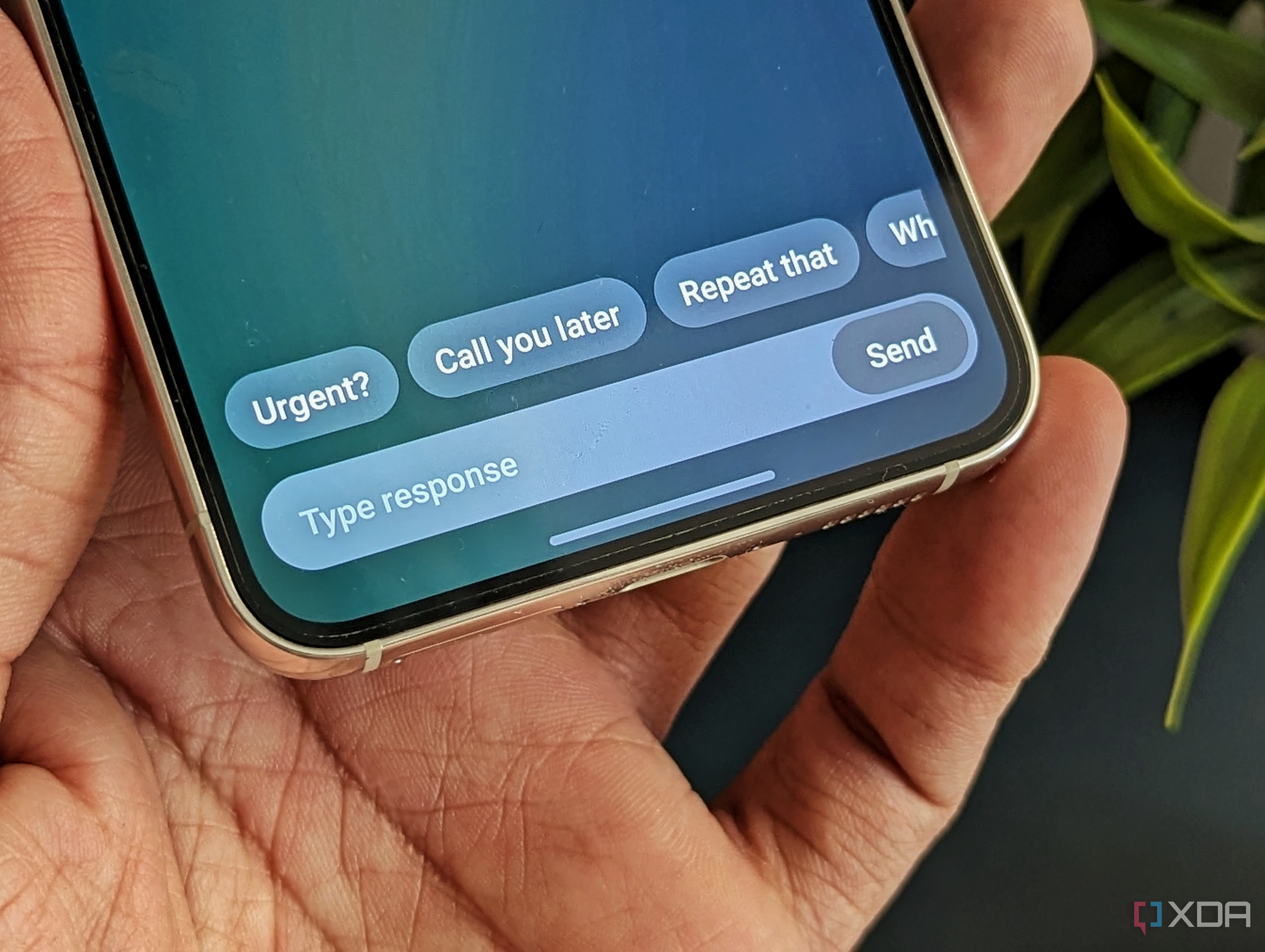 An image of a person holding a Galaxy S23 showing the Bixby text call feature in action.