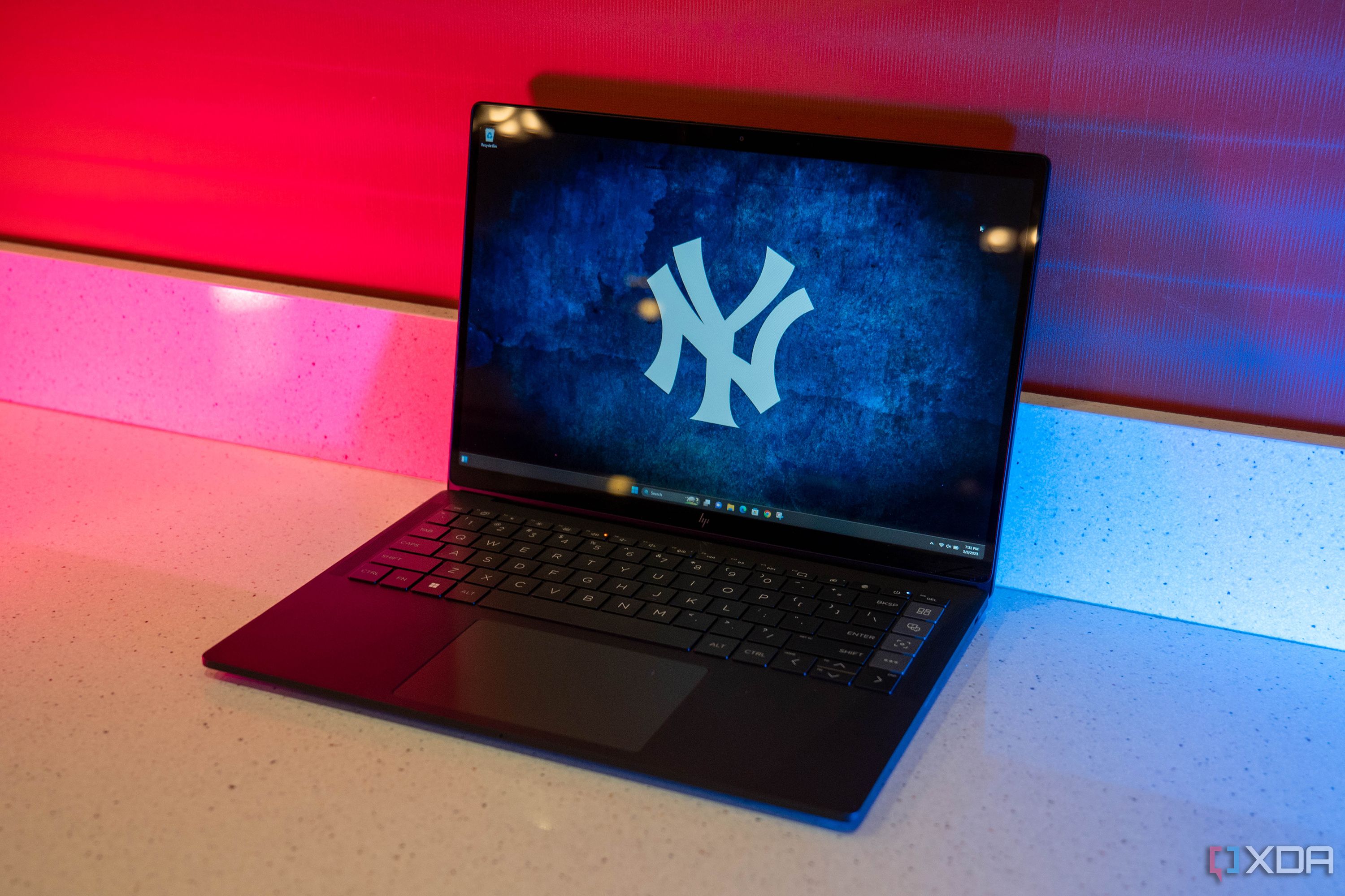 Angled view of black HP laptop with Yankees wallpaper