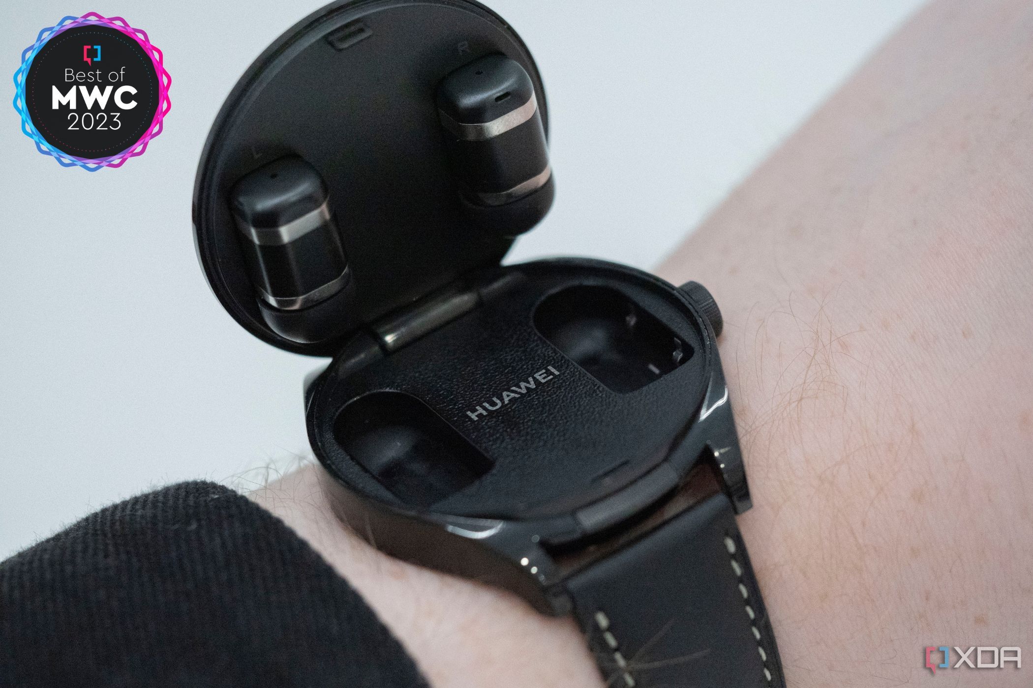 An image showing a person wearing Huawei Watch Buds on their wrist.