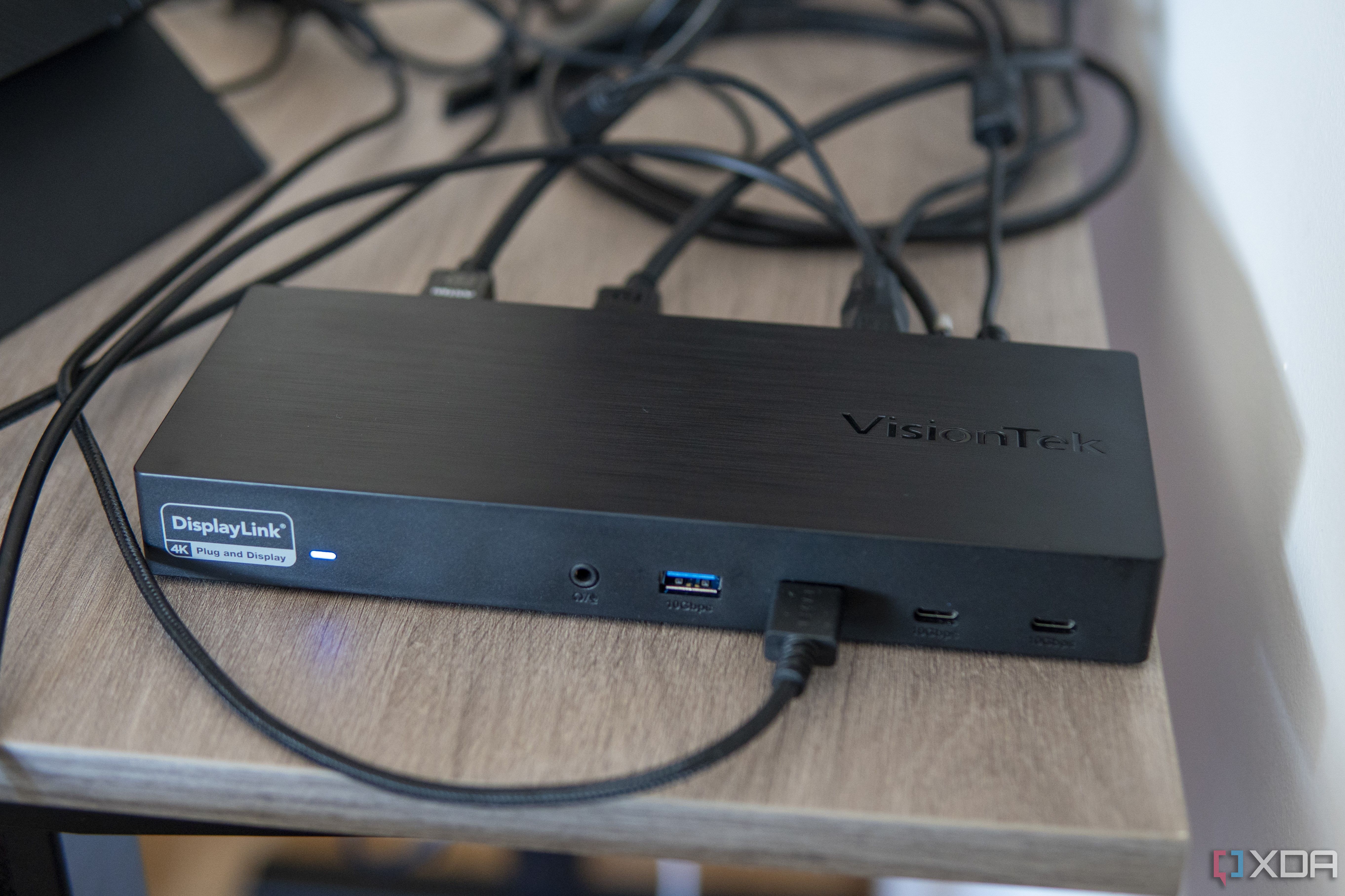 Angled view of the VisionTek VT7400 docking station with various peripherals connected