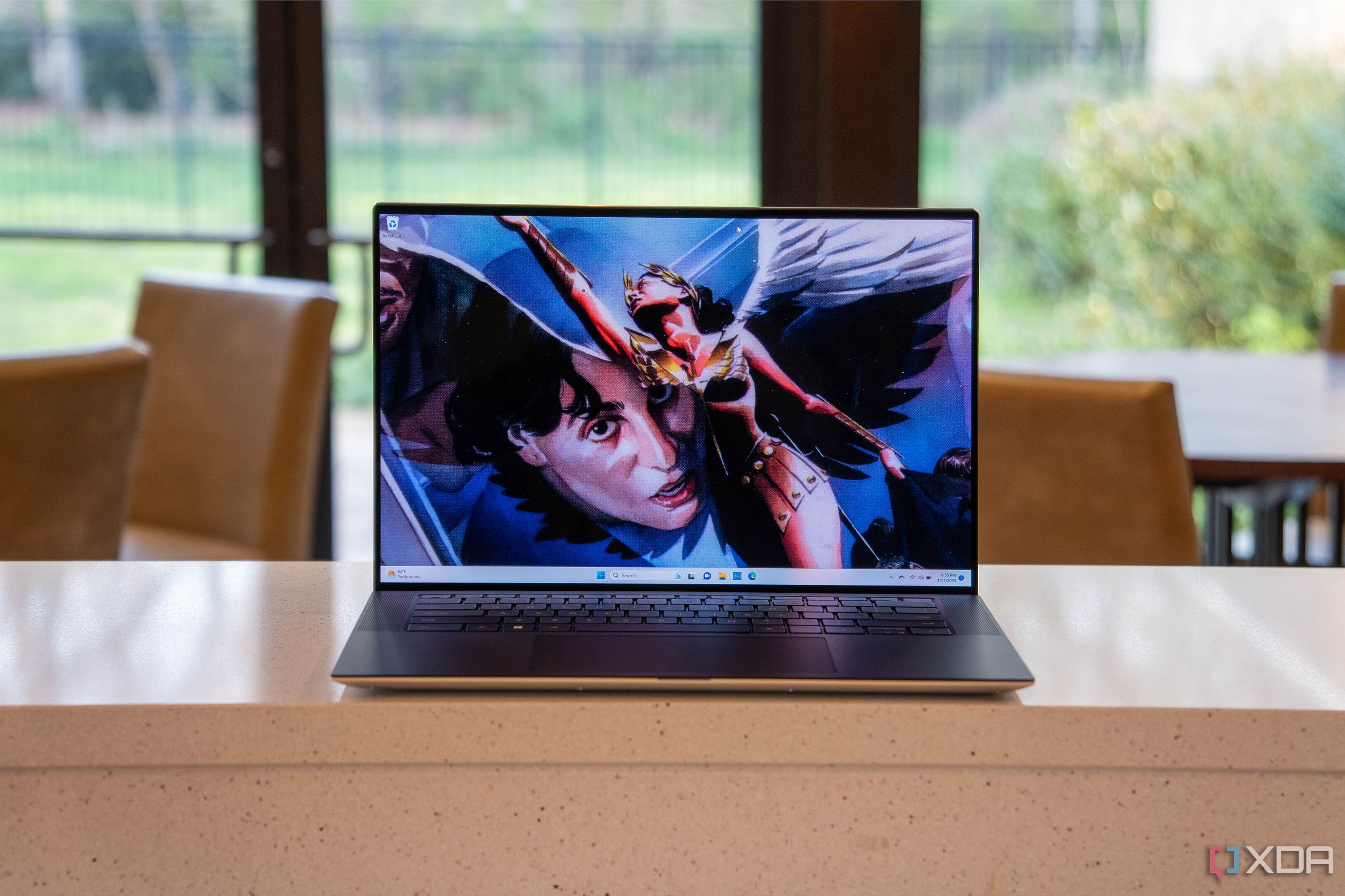 Front view of a laptop with a superhero on the screen