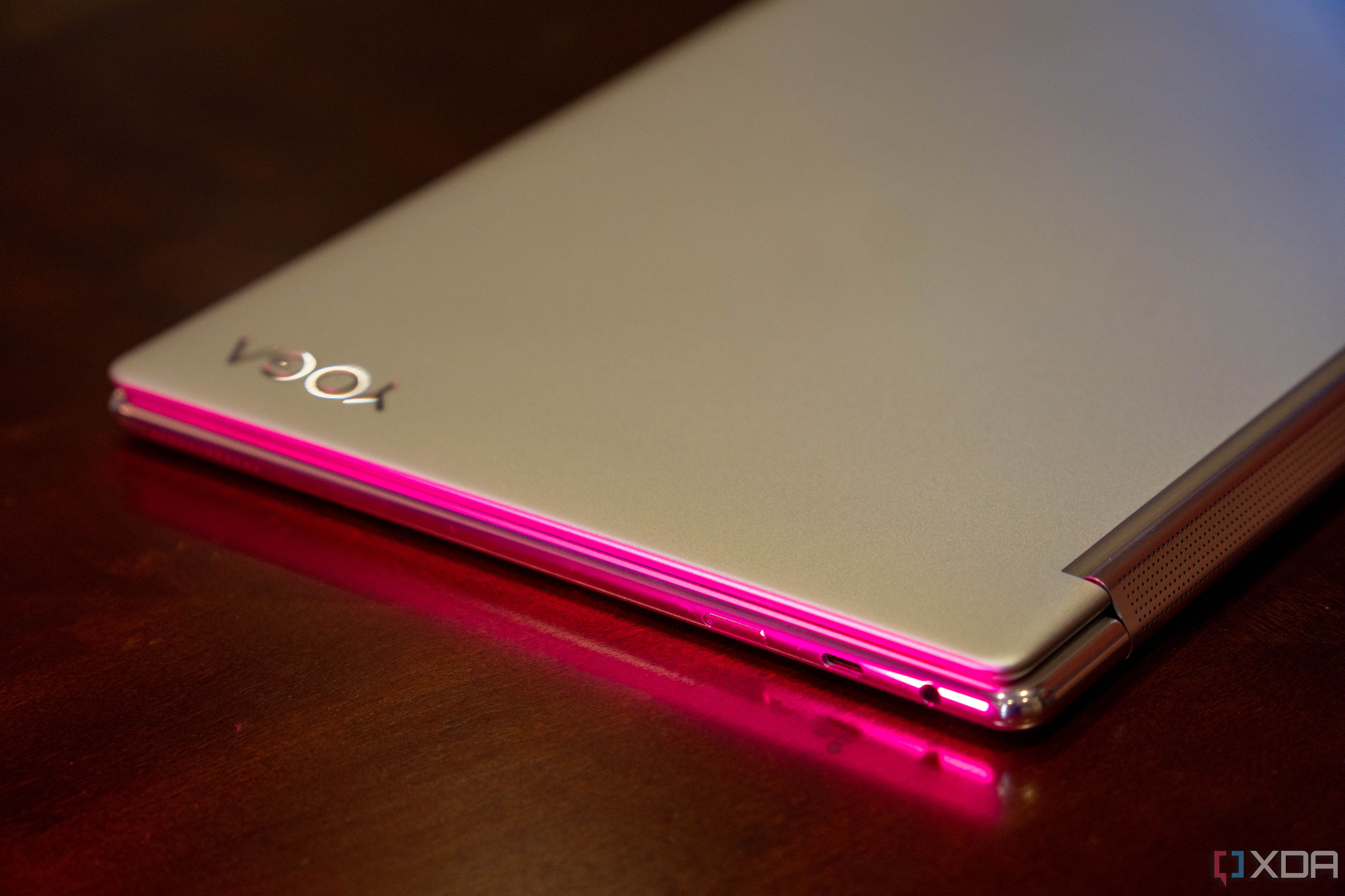Angled view of Lenovo Yoga 9i laptop with pink lighting