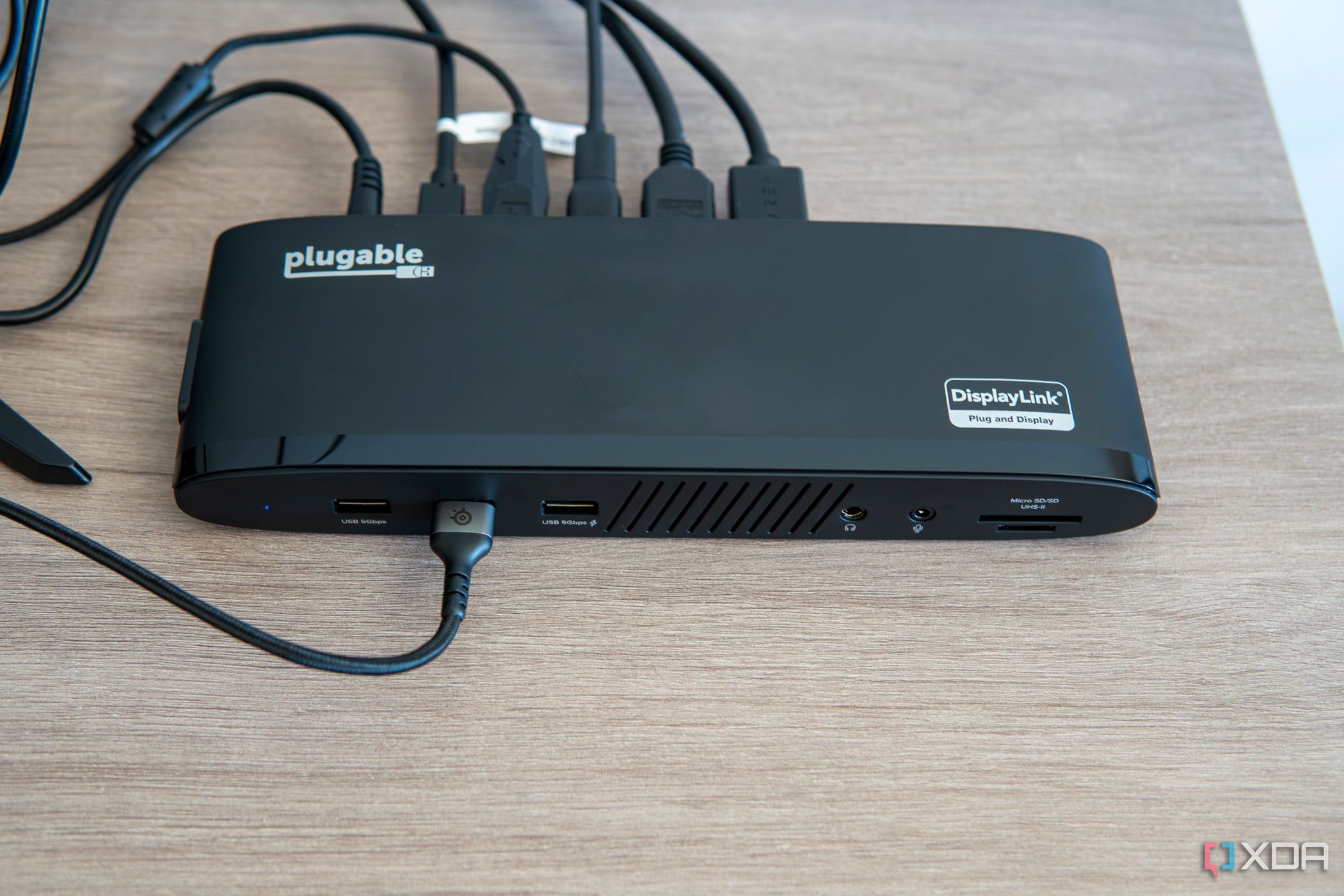 Angled overhead view of the Plugable UD-3900PDH dock with multiple accessories connected