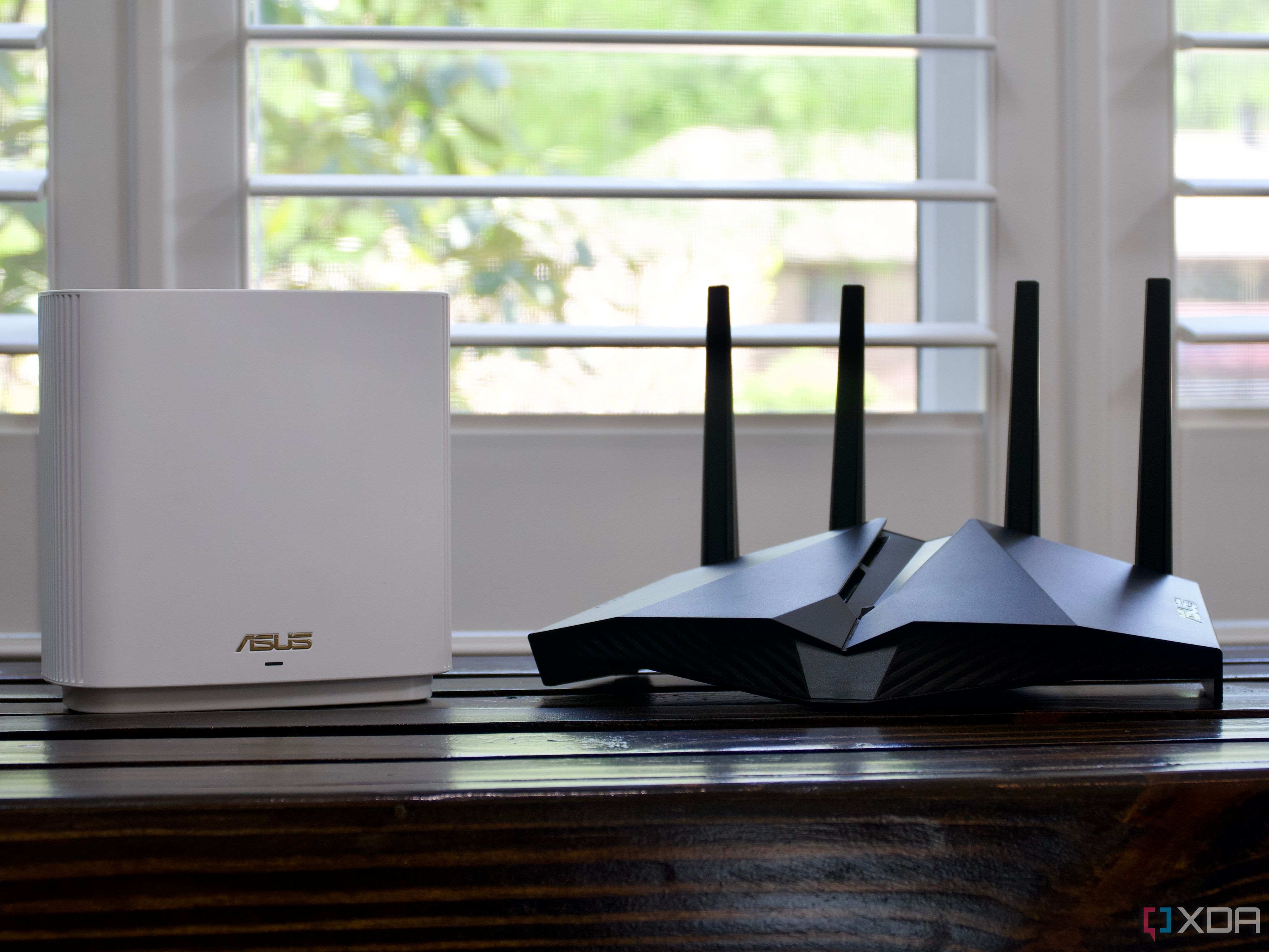 ASUS ZenWiFi ET8 router and AX82U on a bench