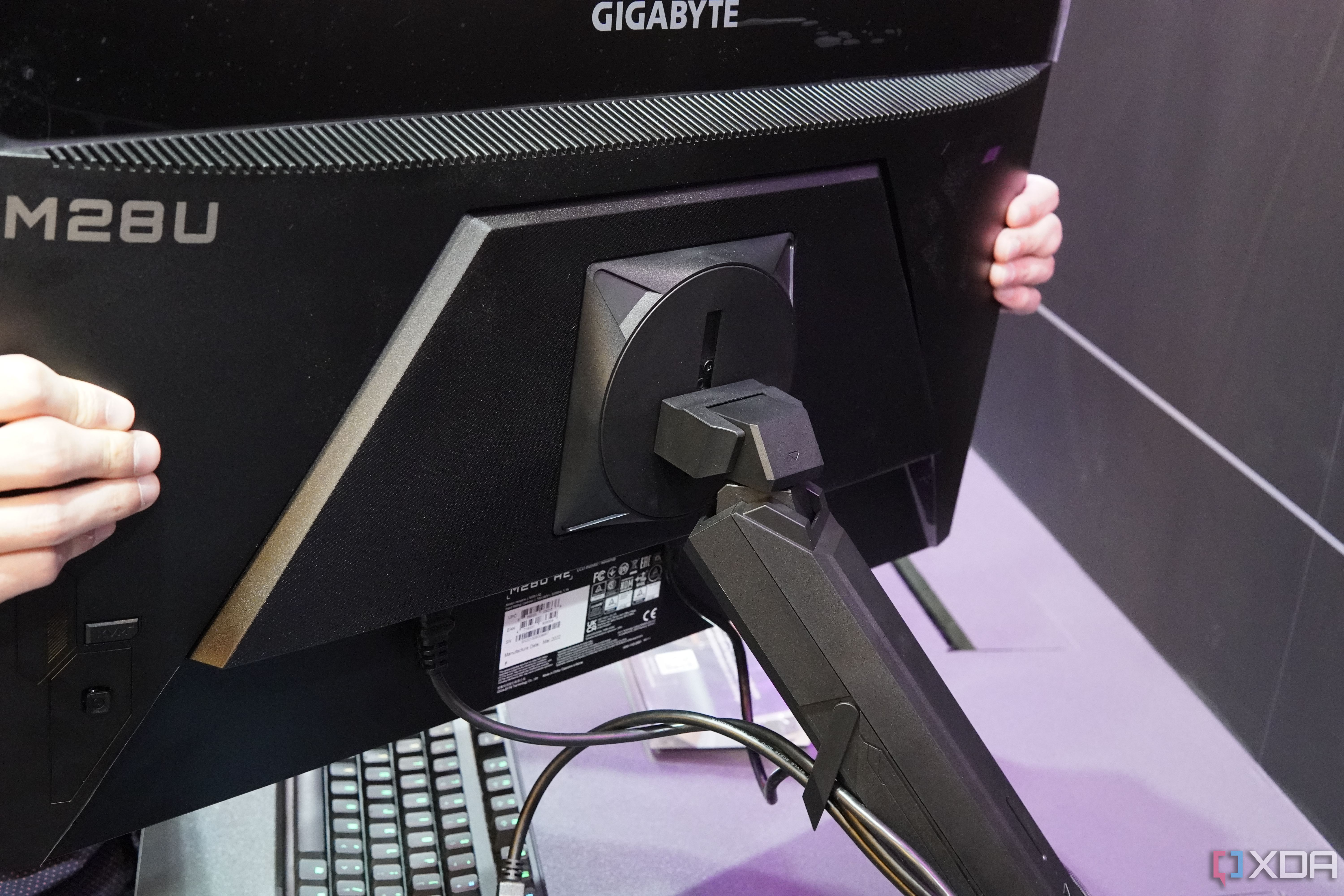 Back view of the Gigabyte M28U Arm Edition showing the mounting arm attached to the monitor