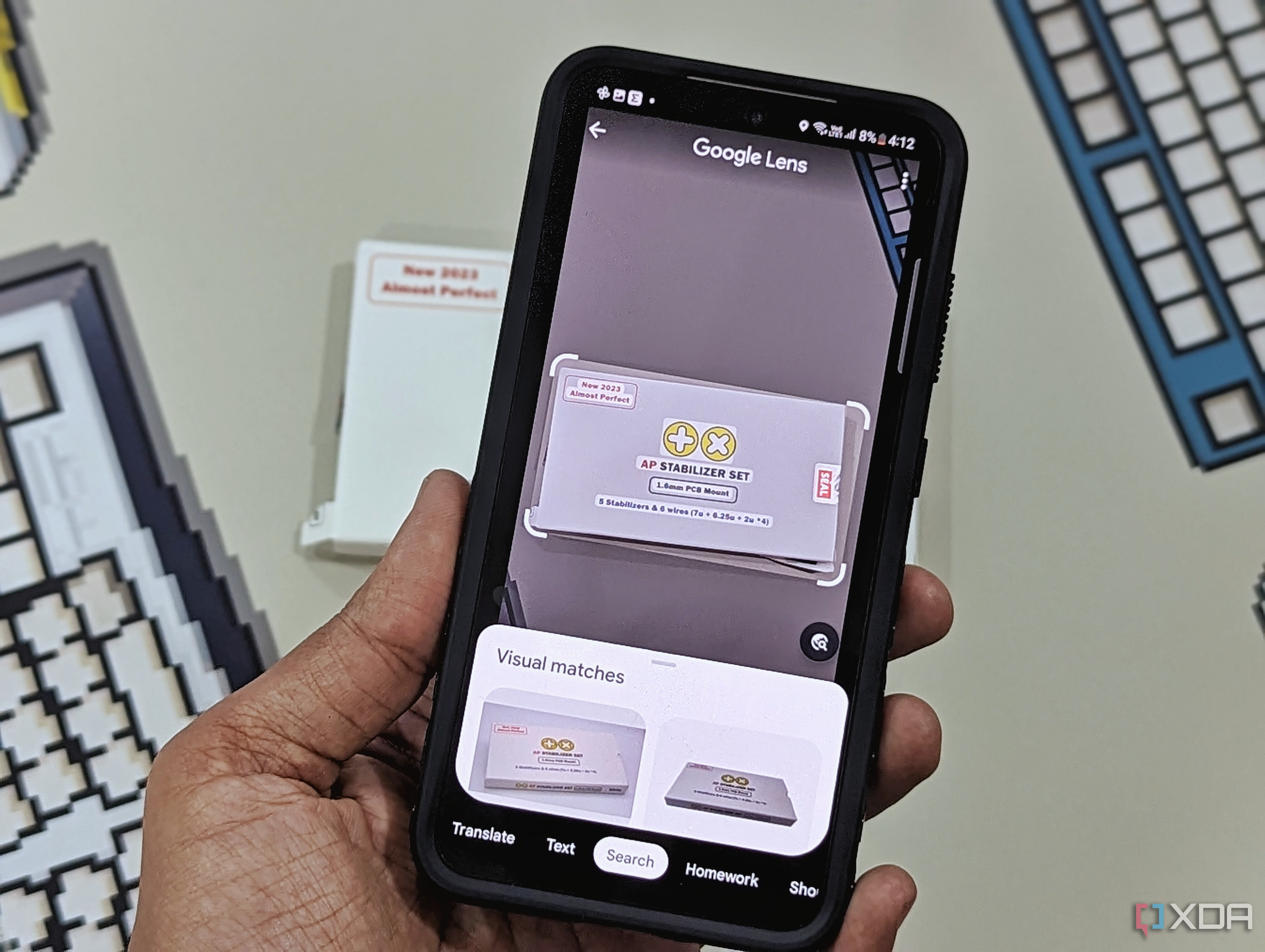 An image showing a person scanning an object with Google Lens on a Galaxy S23.