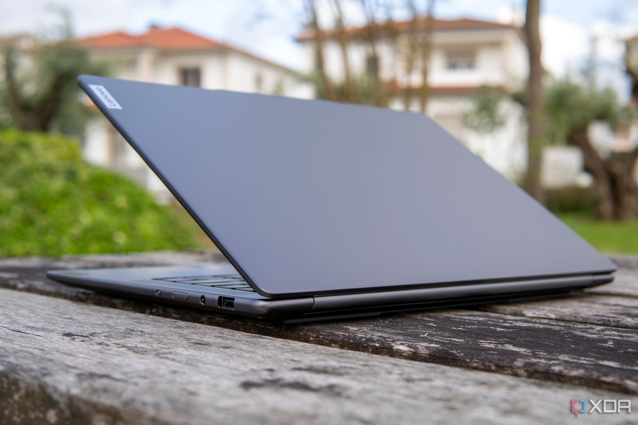 Angled eye-level rear view of the Lenovo Slim Pro 7 with the lid open at around 45 degrees