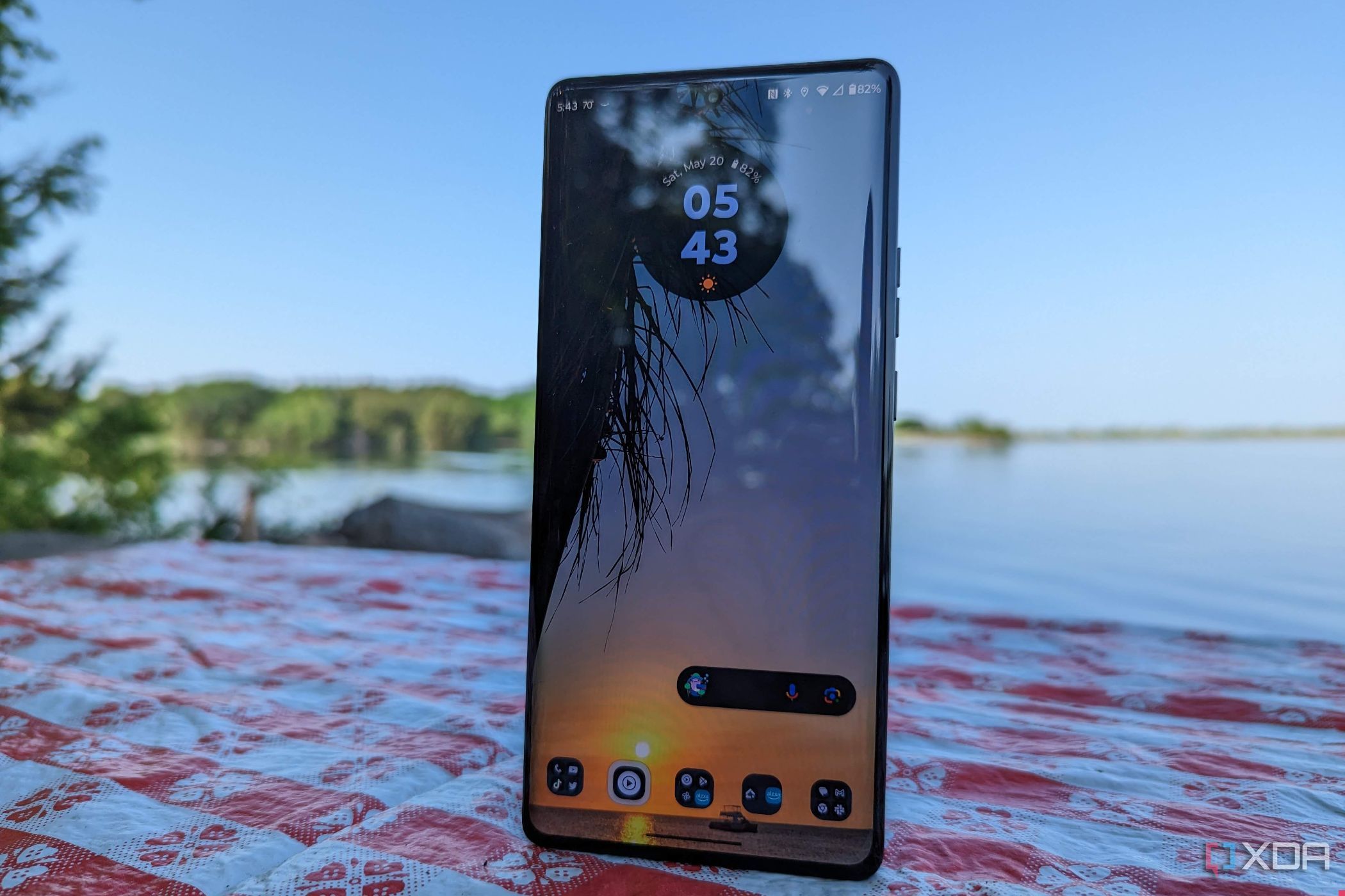 Motorola Edge+ 2023 on a table in front of a lake