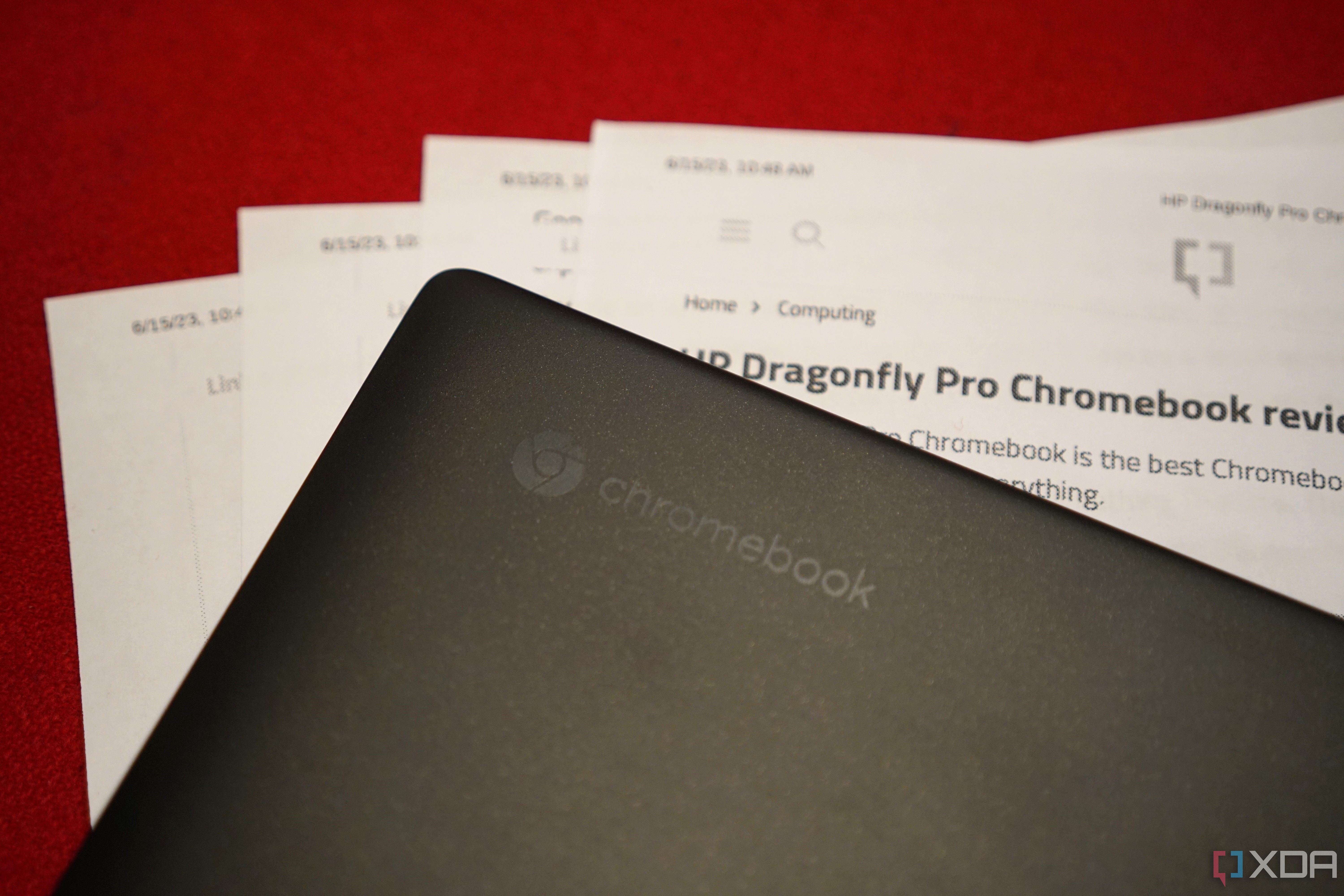 The HP Dragonfly Pro Chromebook laid on top of printed documents.