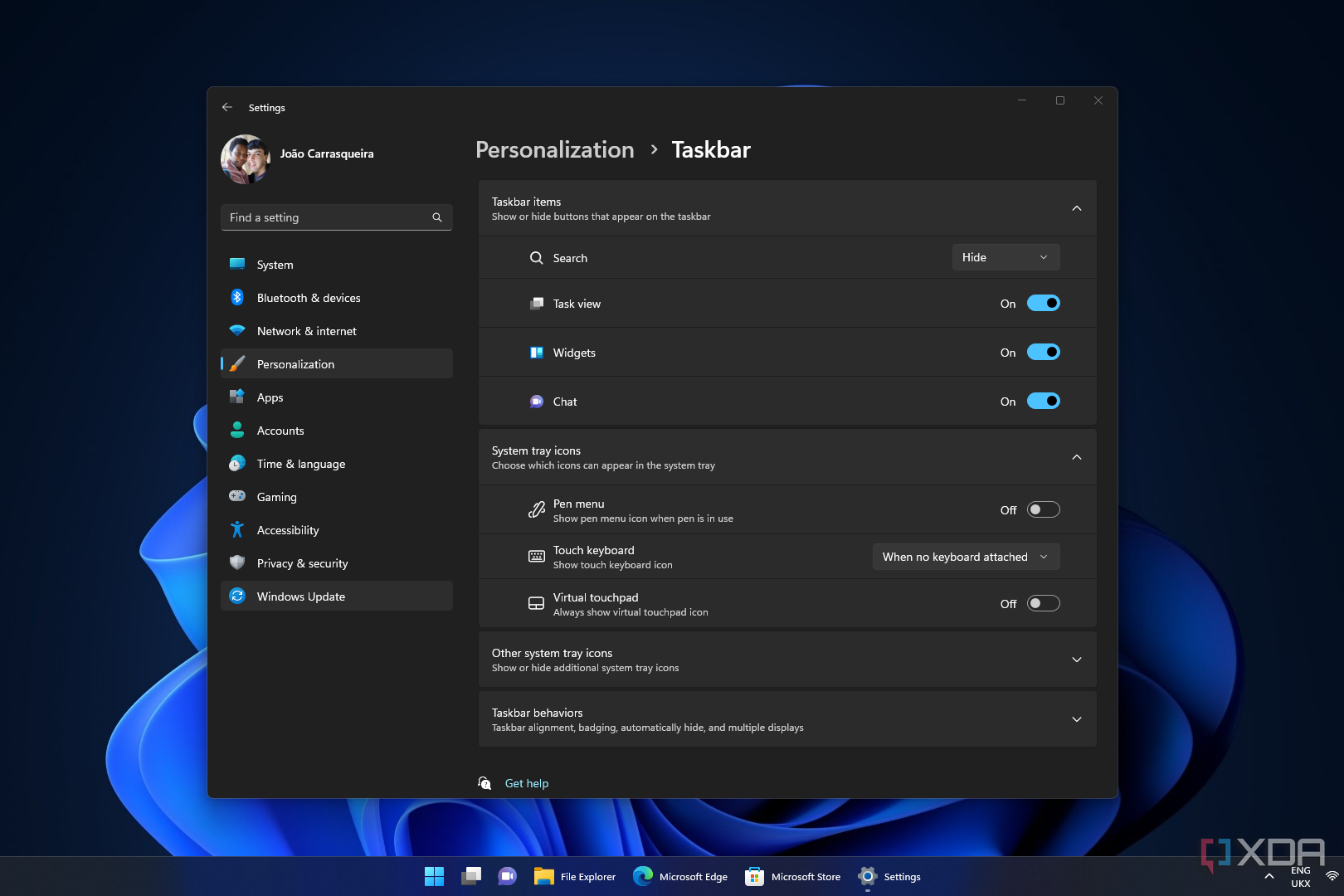 Screenshot of a Windows 11 desktop running the Settings app and showing labels on the taskbar